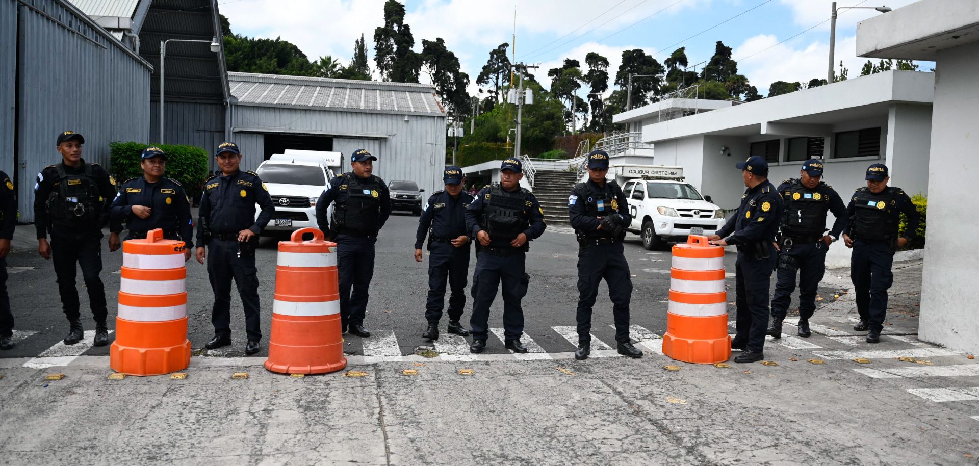 Police officers remain at the entrance of the Electoral Process Operations Center during government raids in Guatemala City on Sept. 12, 2023.