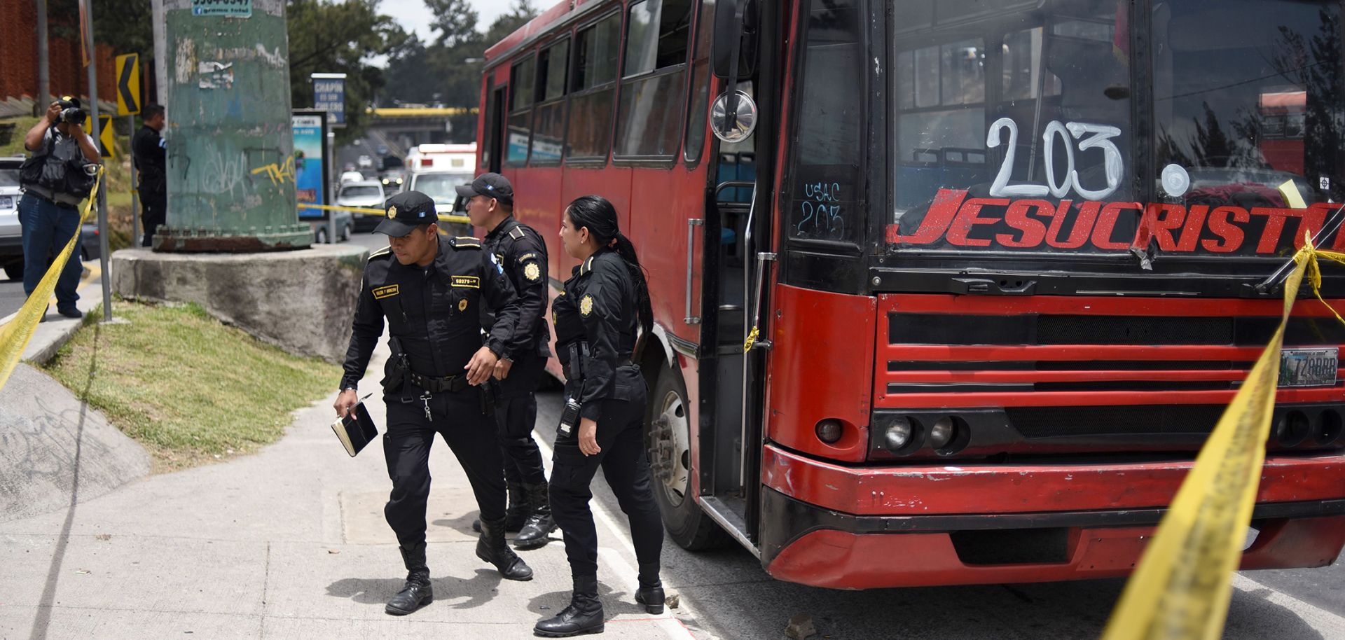 Police inspect one of four buses attacked by alleged gang members July 13, 2018, in Guatemala City.