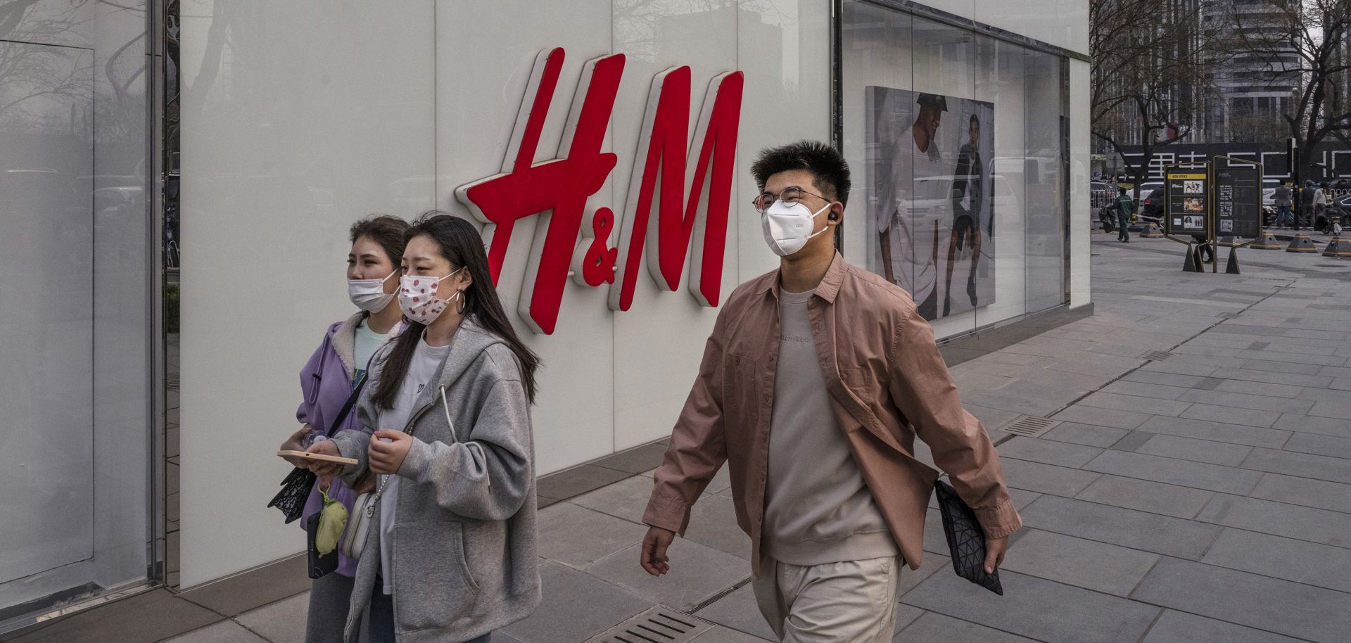 People walk past an H&M store in Beijing, China, on March 25, 2021. 