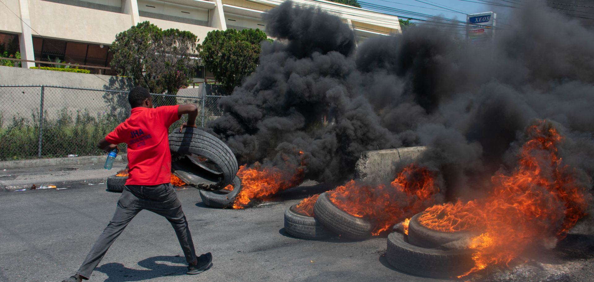 A protester burns tires during a demonstration in Port-au-Prince, Haiti, on March 12, 2024, after Haitian Prime Minister Ariel Henry announced his plans to resign. 