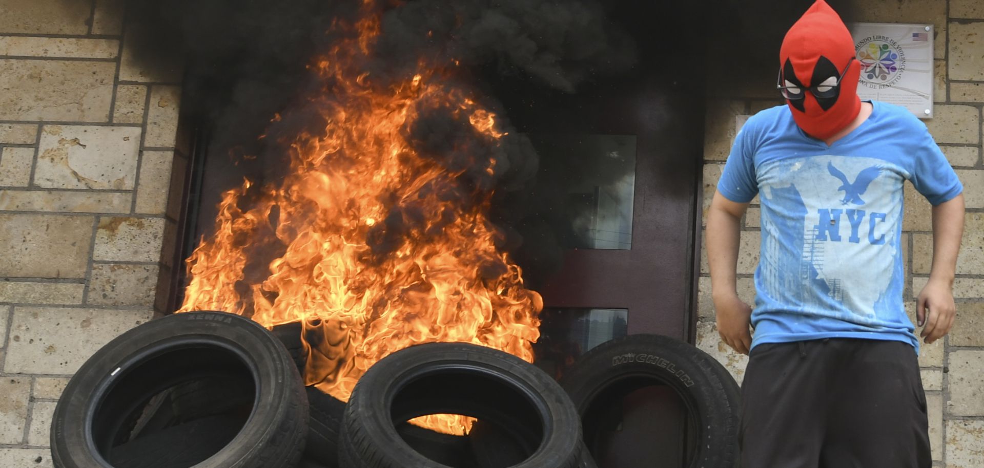 A tire fire burns at the doors to the outer entrance of the U.S. Embassy in Tegucigalpa on May 31, 2019.