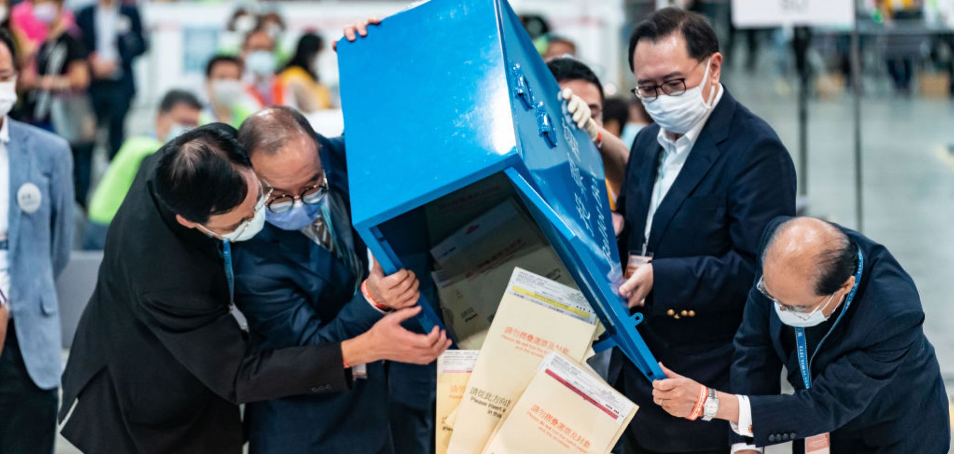 Officials open a ballot box as vote counting starts Sept. 19, 2021, in Hong Kong.