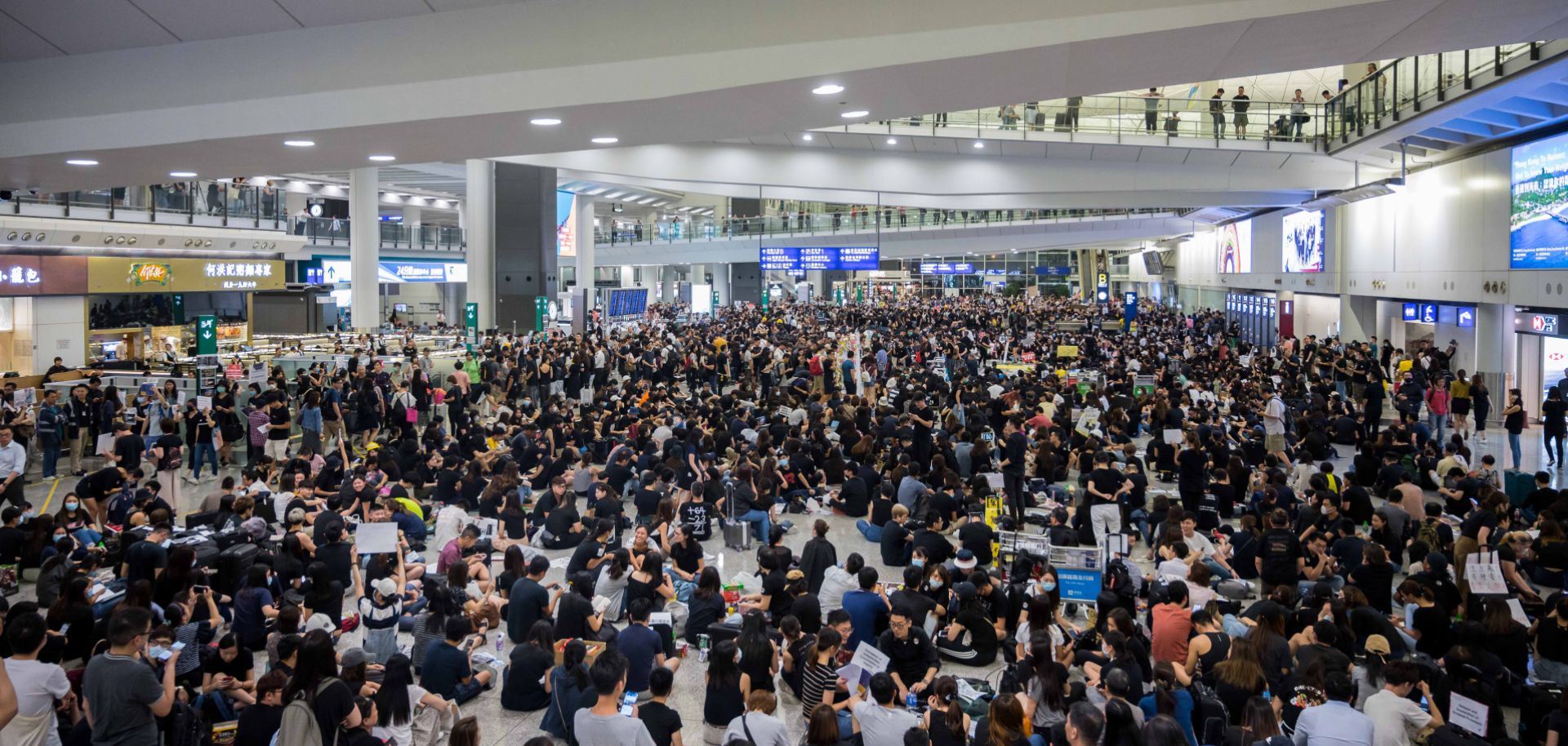 Pro-democracy protesters fill the arrivals terminal of Hong Kong International Airport on July 26, 2019.