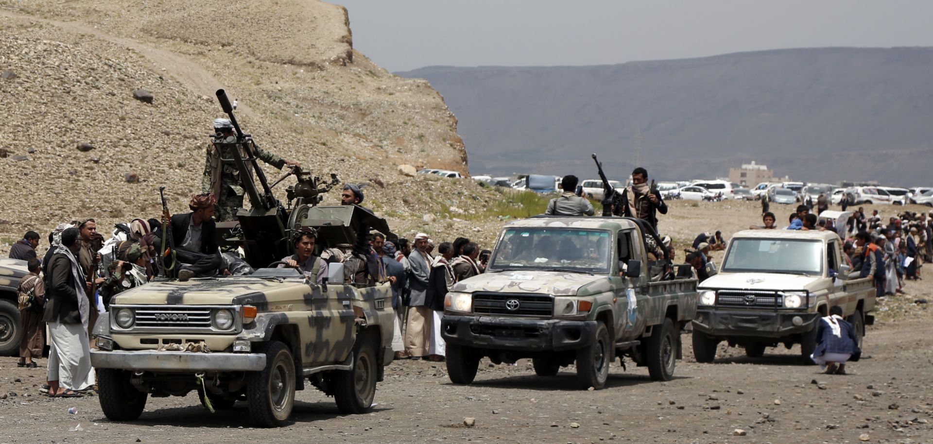 Houthi-allied tribesmen ride trucks mounted with machine guns on the outskirts of Sanaa, Yemen, on July 8, 2020. 