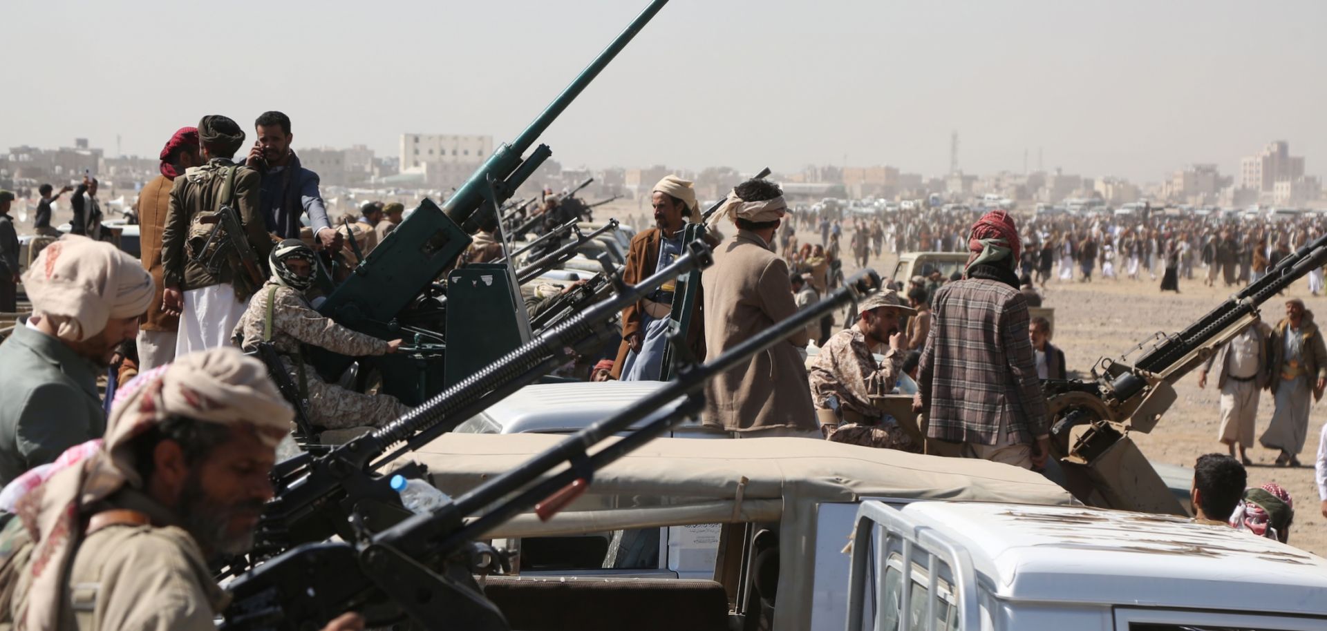 Yemen's Houthi fighters man machine guns mounted on trucks as they participate in a weaponized protest staged against the United States and Israel on Nov. 6, 2025 in Sanaa, Yemen. 