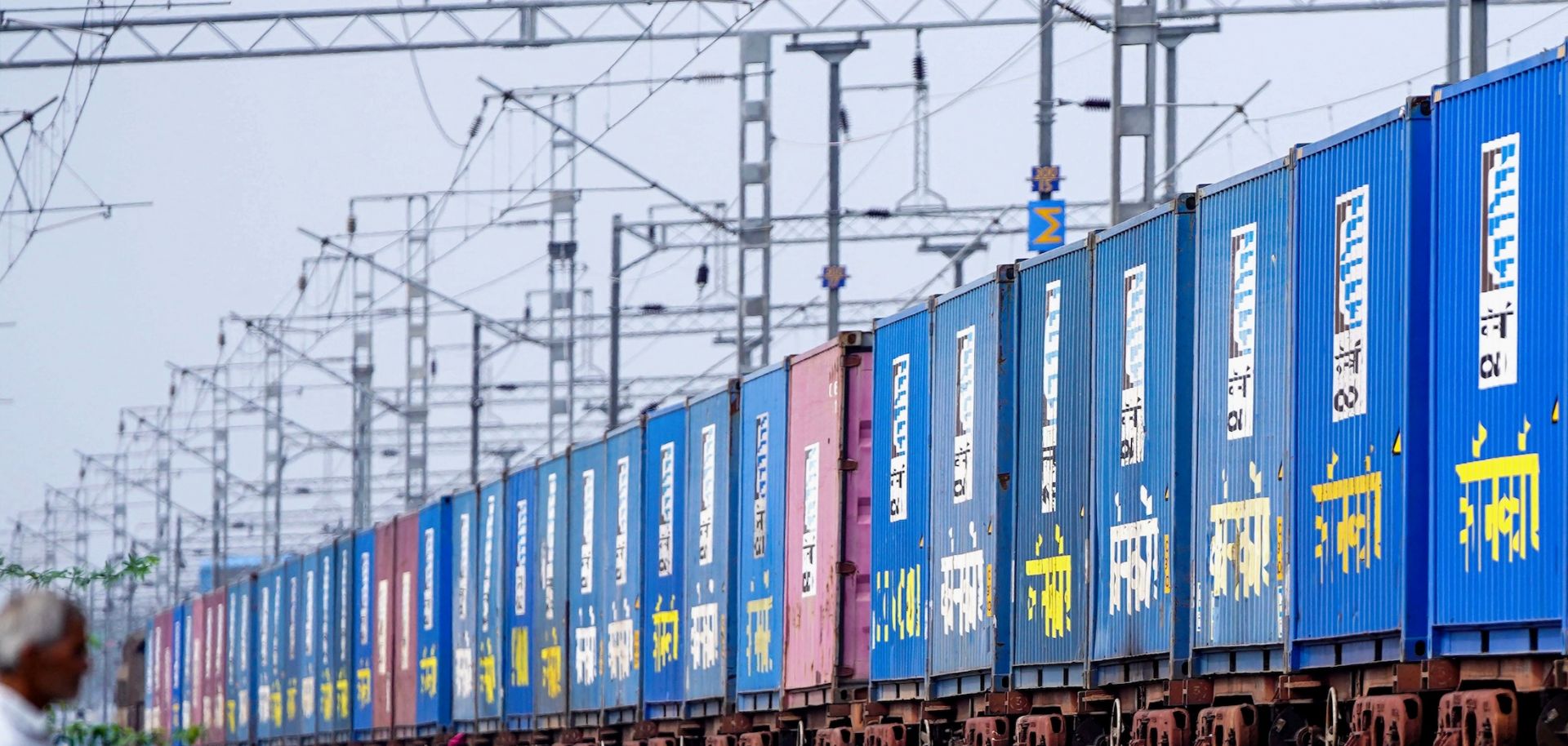 A freight train carrying cargo containers rides along a railway track in Ajmer, India, on Aug. 26, 2025.