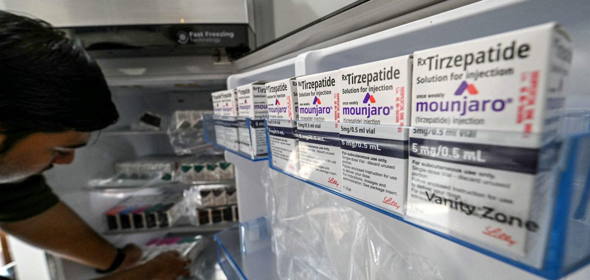A medicine distributor stores Mounjaro (tirzepatide) self-injecting GLP-1 prefilled pens and vials in a fridge at his office in Thane, India, on March 20, 2026. 