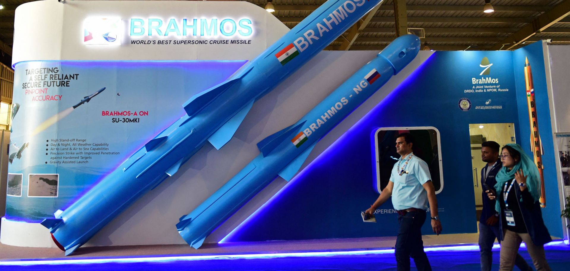 Visitors walk past a model of India's BrahMos supersonic cruise missile at the Defense Expo 2022 in India's Gandhinagar state on Oct. 18, 2022.