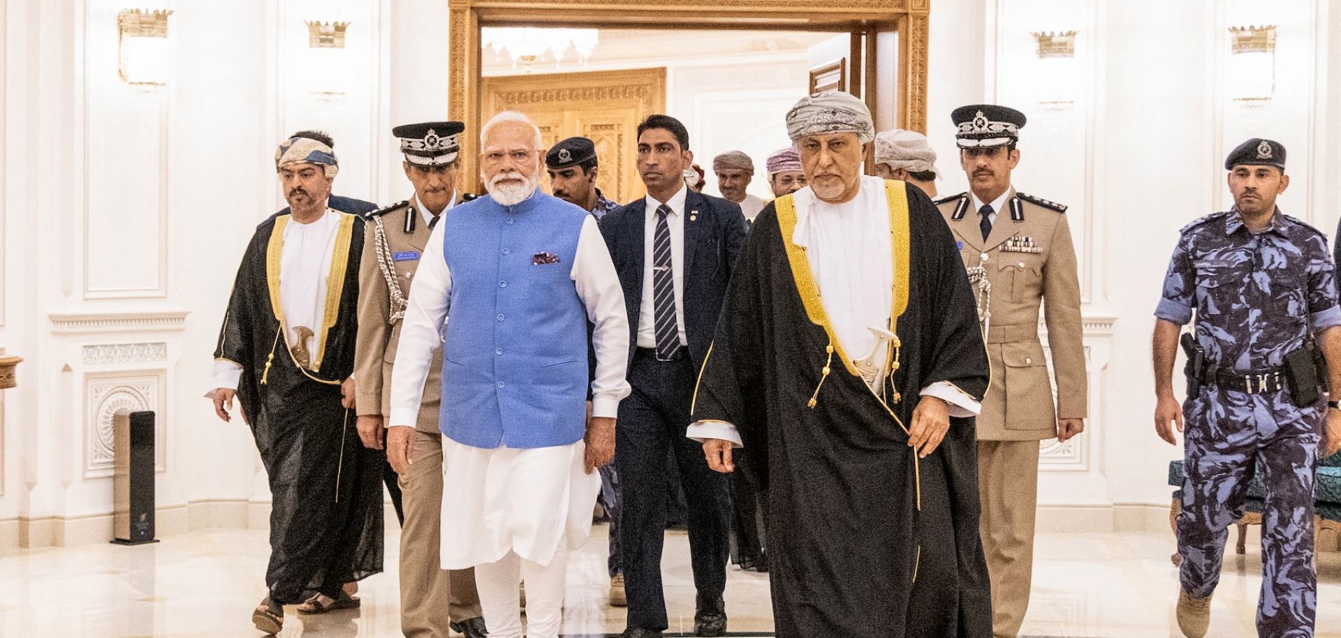 Indian Prime Minister Narendra Modi walks alongside Oman's Deputy Prime Minister for Defence Affairs Sayyid Shihab bin Tariq al-Said upon his arrival in Muscat on Dec. 17, 2025.