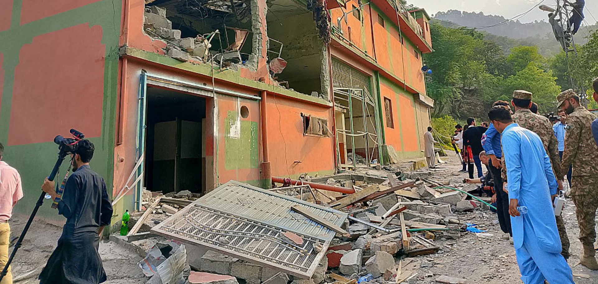 Soldiers and onlookers inspect the debris of a mosque damaged by Indian strikes in Muzaffarabad, the capital of Pakistan-administered Kashmir, on May 7, 2025.