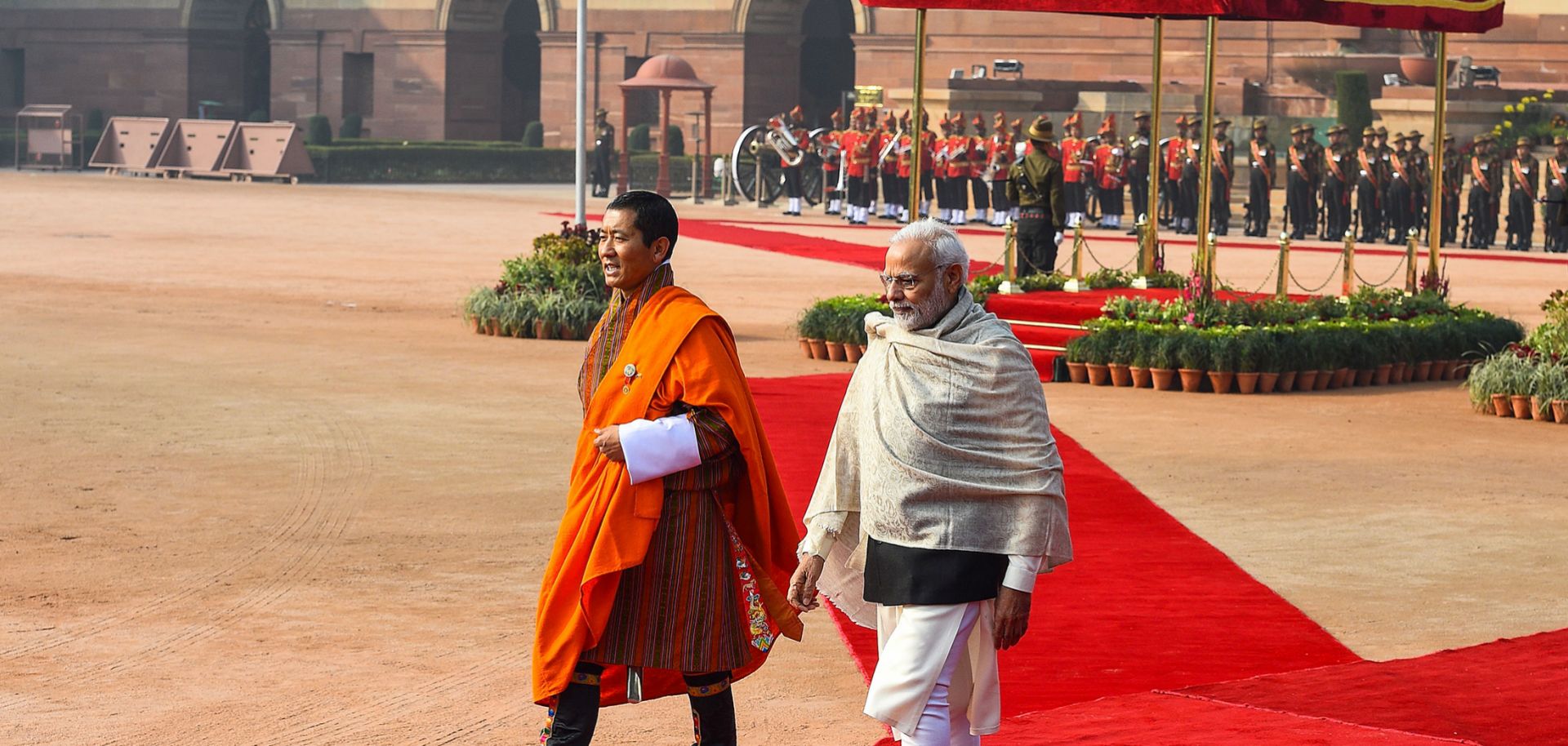 Indian Prime Minister Narendra Modi (R) walks with Bhutanese Prime Minister Lotay Tshering during a ceremonial reception at the Presidential Palace in New Delhi on Dec. 28, 2018.