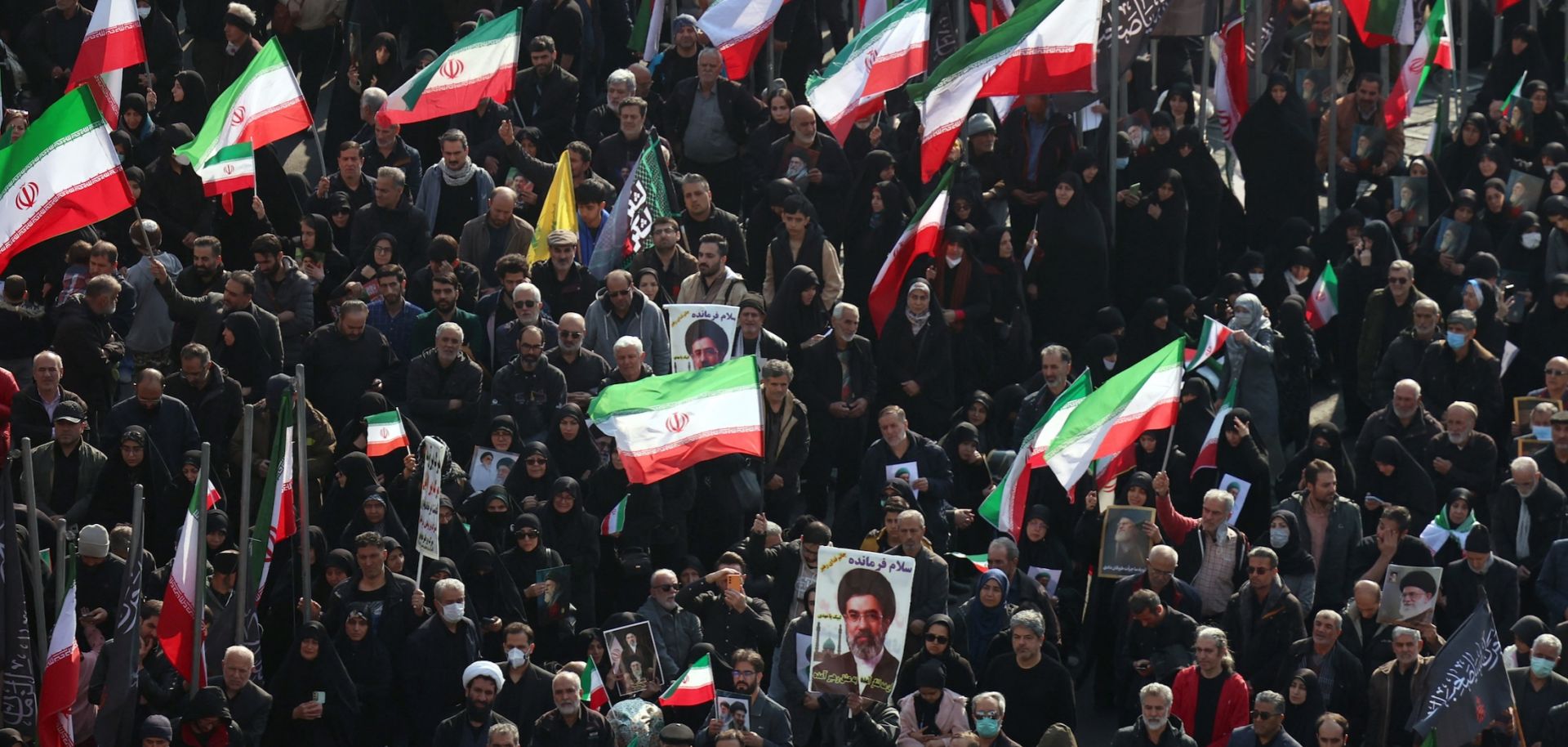 Demonstrators wave Iranian national flags and hold pictures of the country's new supreme leader, Mojtaba Khamenei, at Enghelab Square in central Tehran on March 9, 2026.