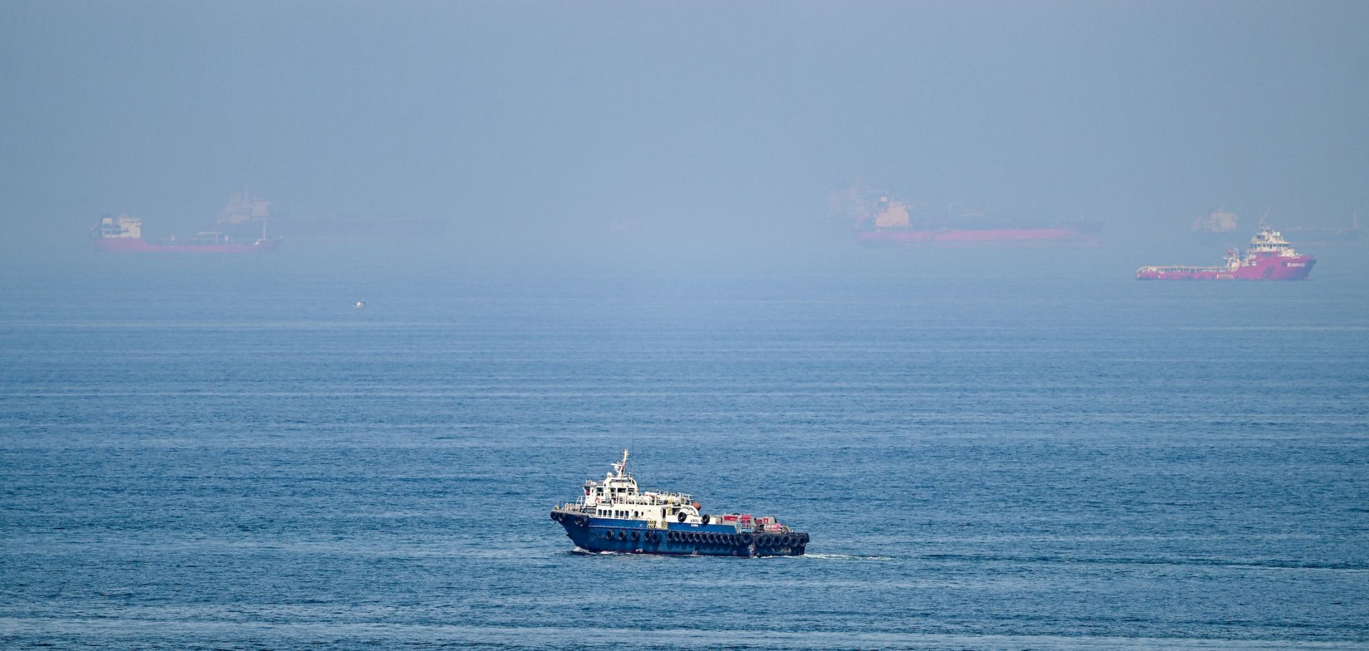 Cargo ships June 19 off the coast of the Khor Fakkan Container Terminal in Sharjah emirate, along the Gulf of Oman. On the heels of growing domestic political pushback in the United States, Washington and Tehran will enter a second week of the 60-day ceasefire.