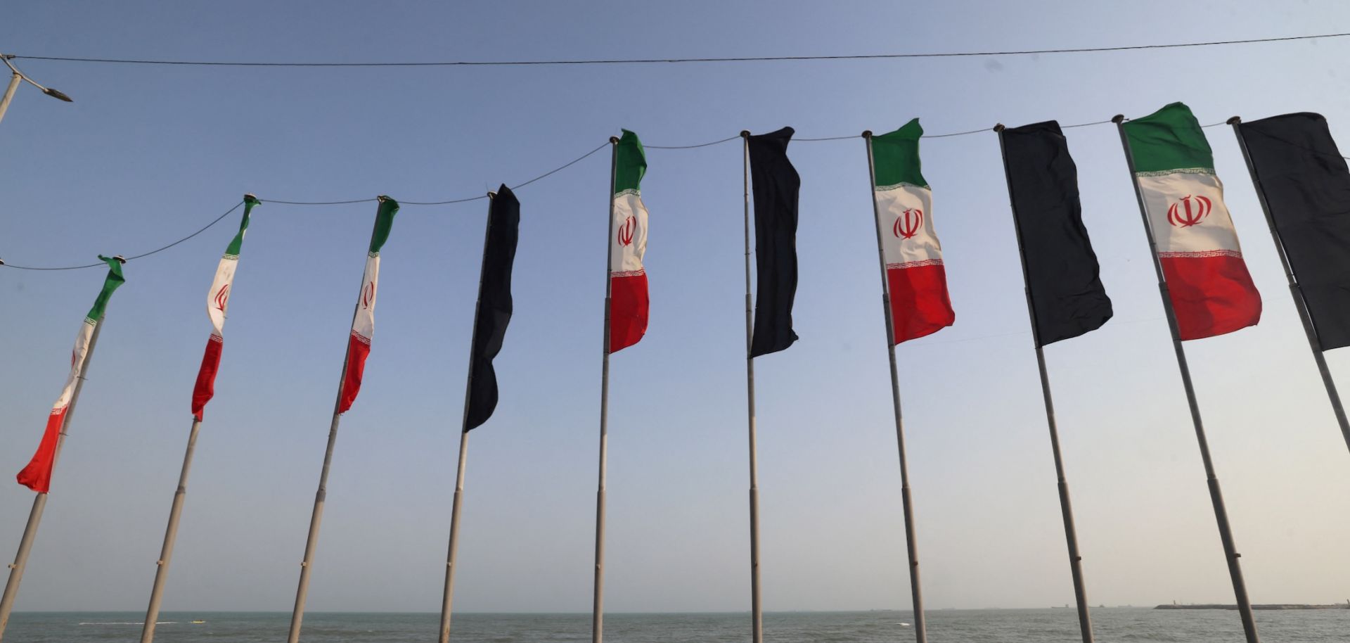 Iranian flags flutter along the corniche seafront of the port city of Bandar Abbas, Iran, on Aug. 10, 2026. 