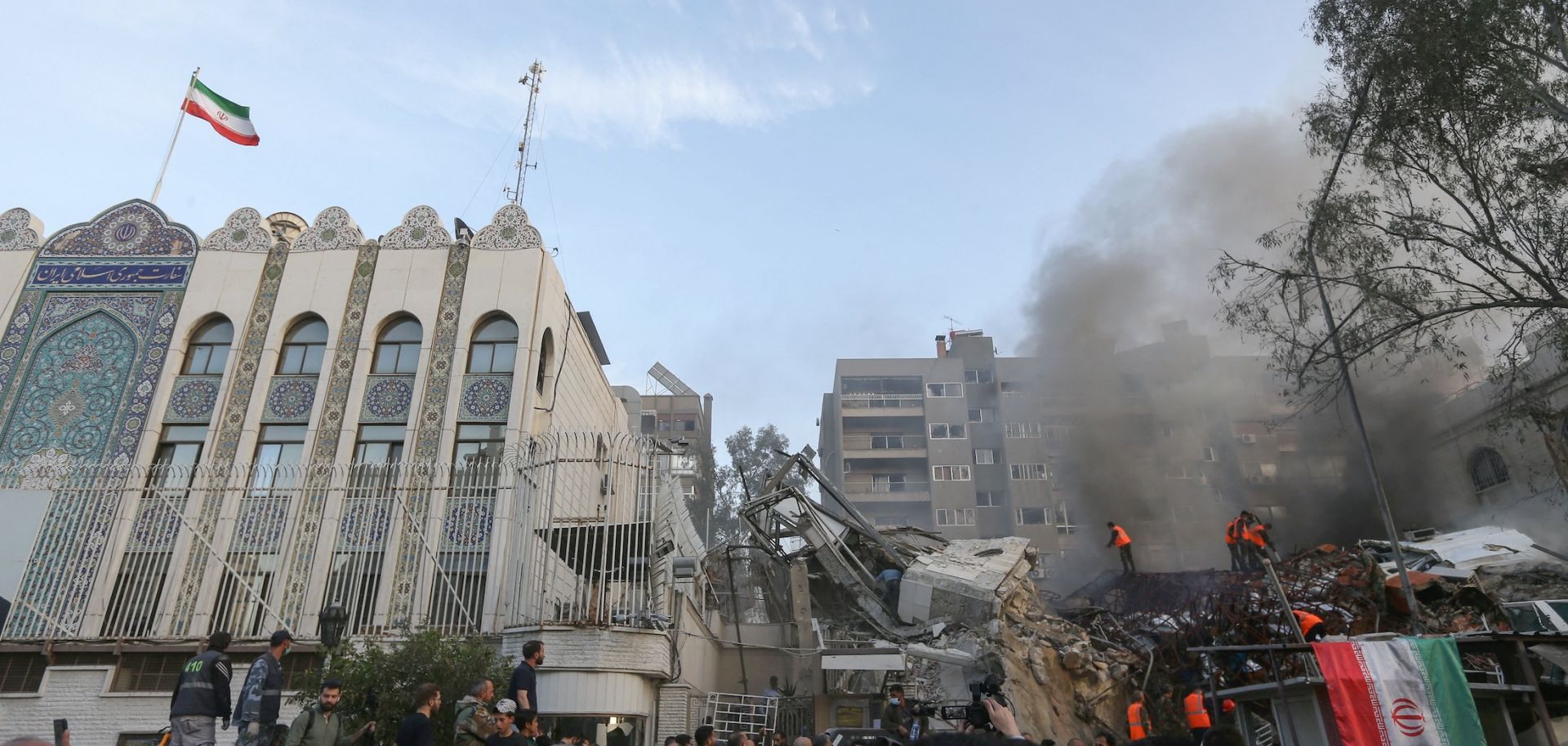 Emergency and security personnel search rubble at the site of an April 1, 2024, strike on the Iranian Consulate in Syria's capital of Damascus.