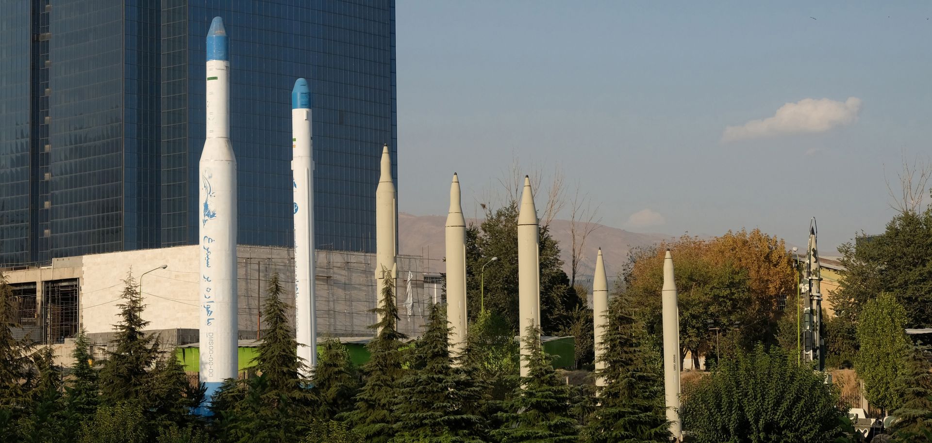 Iranian-made satellite carriers (left) and missiles (right) are displayed in front of the Holy Defense Museum in Tehran, Iran, on Sept. 20, 2020.