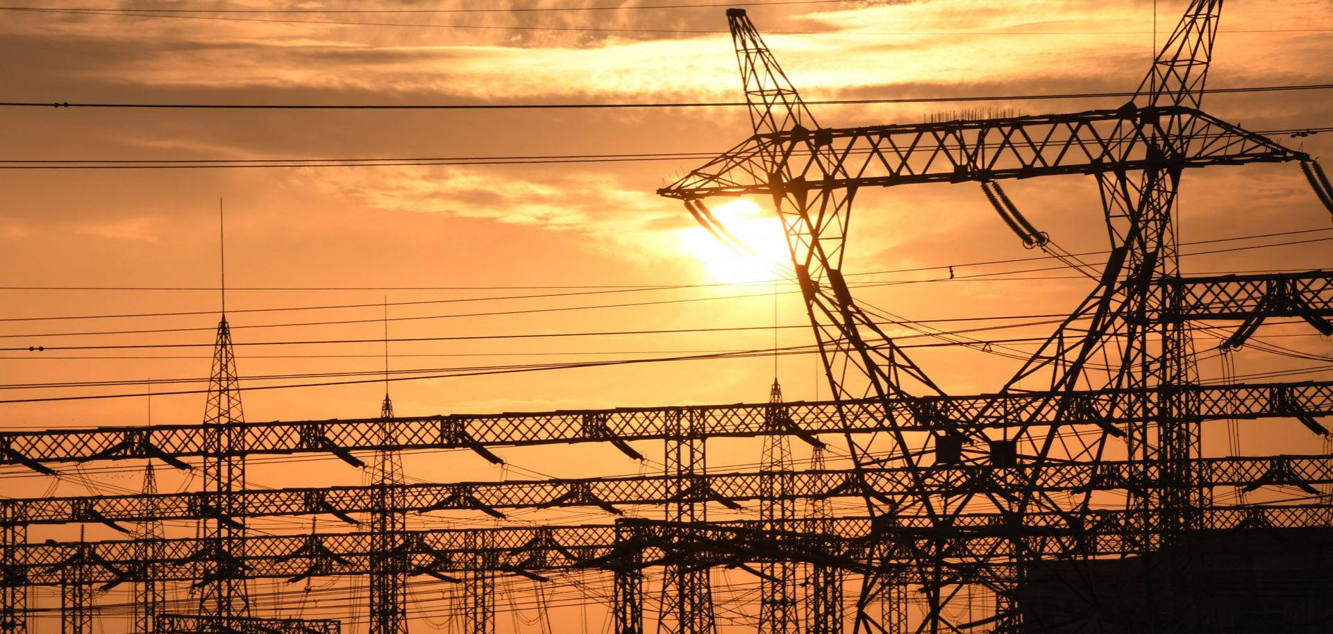 The sun sets behind electrical grids in the southern Iraqi city of Nasiriyah on Jan. 3, 2021. 