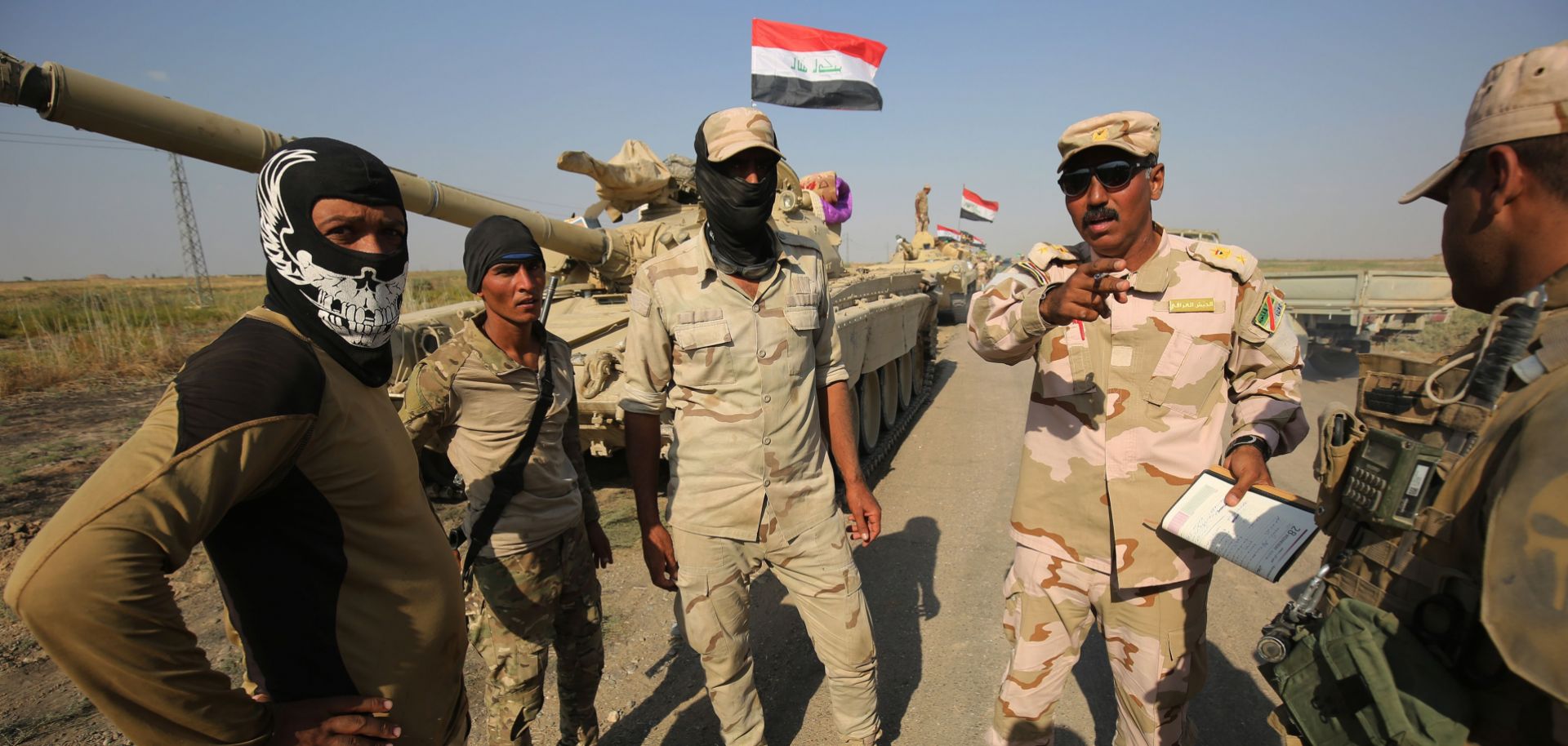 Iraqi Army personnel pause on their advance toward Kurdish peshmerga positions on the southern outskirts of Kirkuk, Oct. 15.