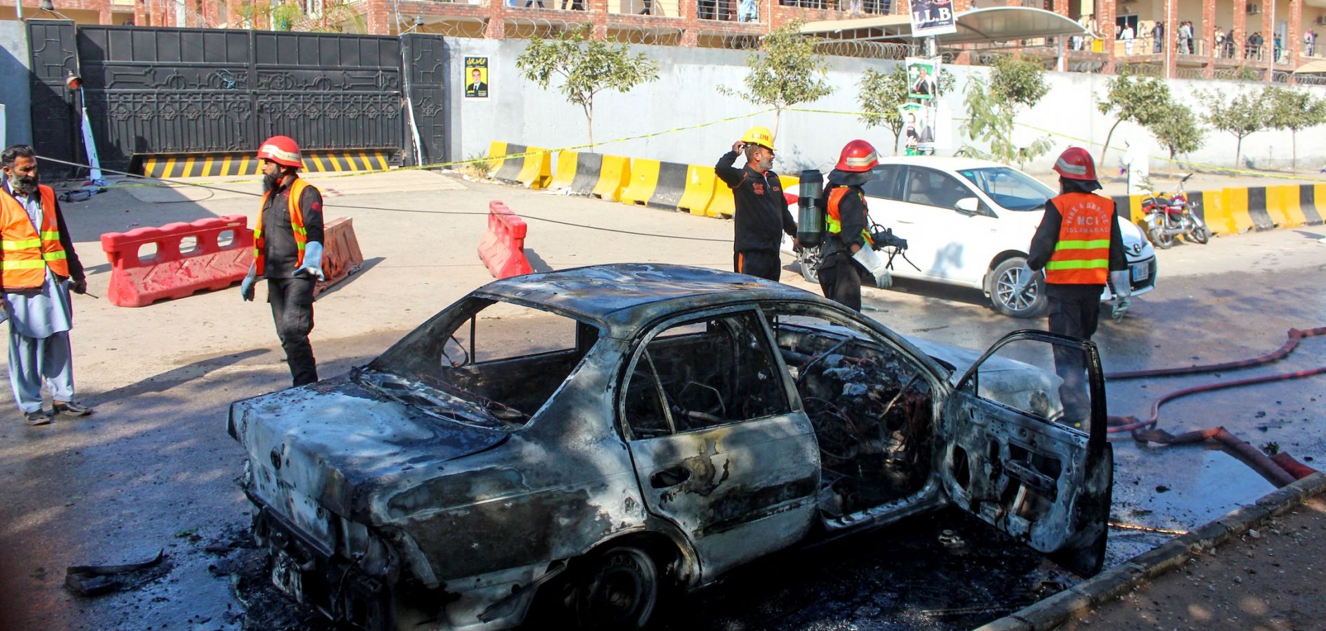 Firefighters douse a car at the suicide blast site in Islamabad, Pakistan, on Nov. 11, 2025. 