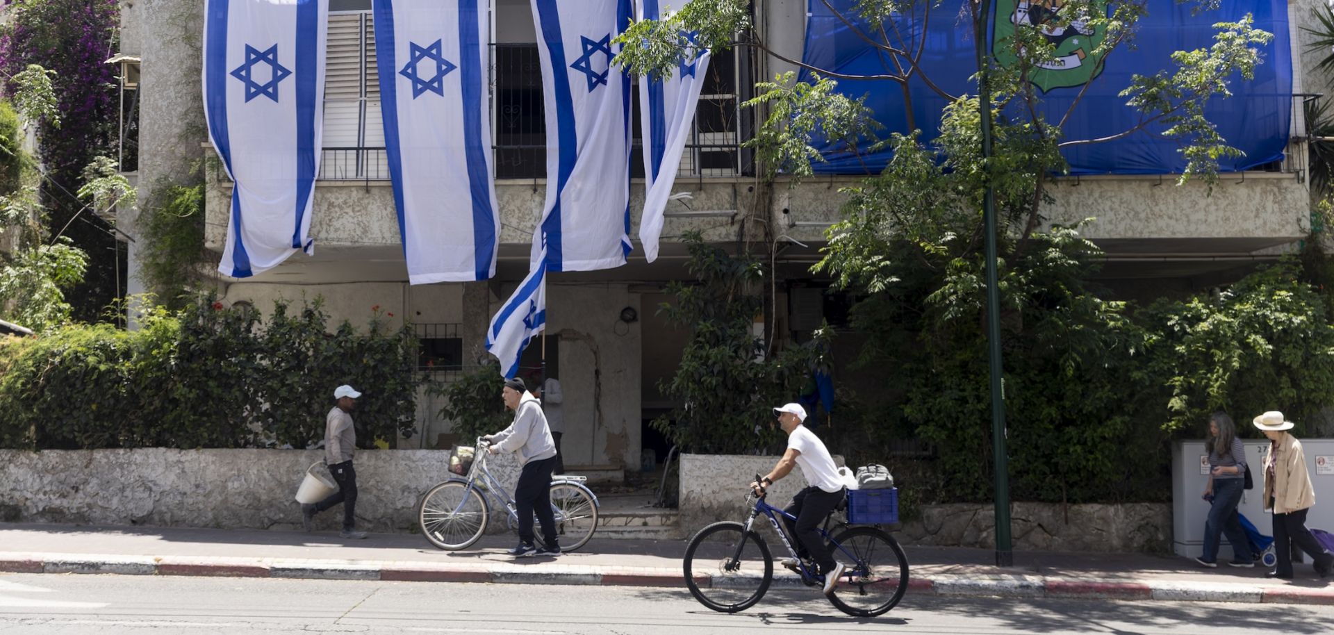 People pass by a building in Ramat Gan, Israel, that was destroyed by an Iranian ballistic missile on May 5, 2026.