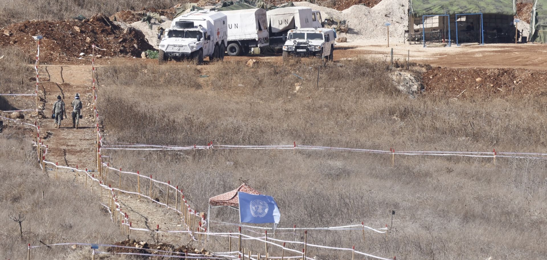 A photograph taken from the Israeli side of the border with southern Lebanon shows U.N. peacekeepers clearing landmines on Nov. 19, 2025. 