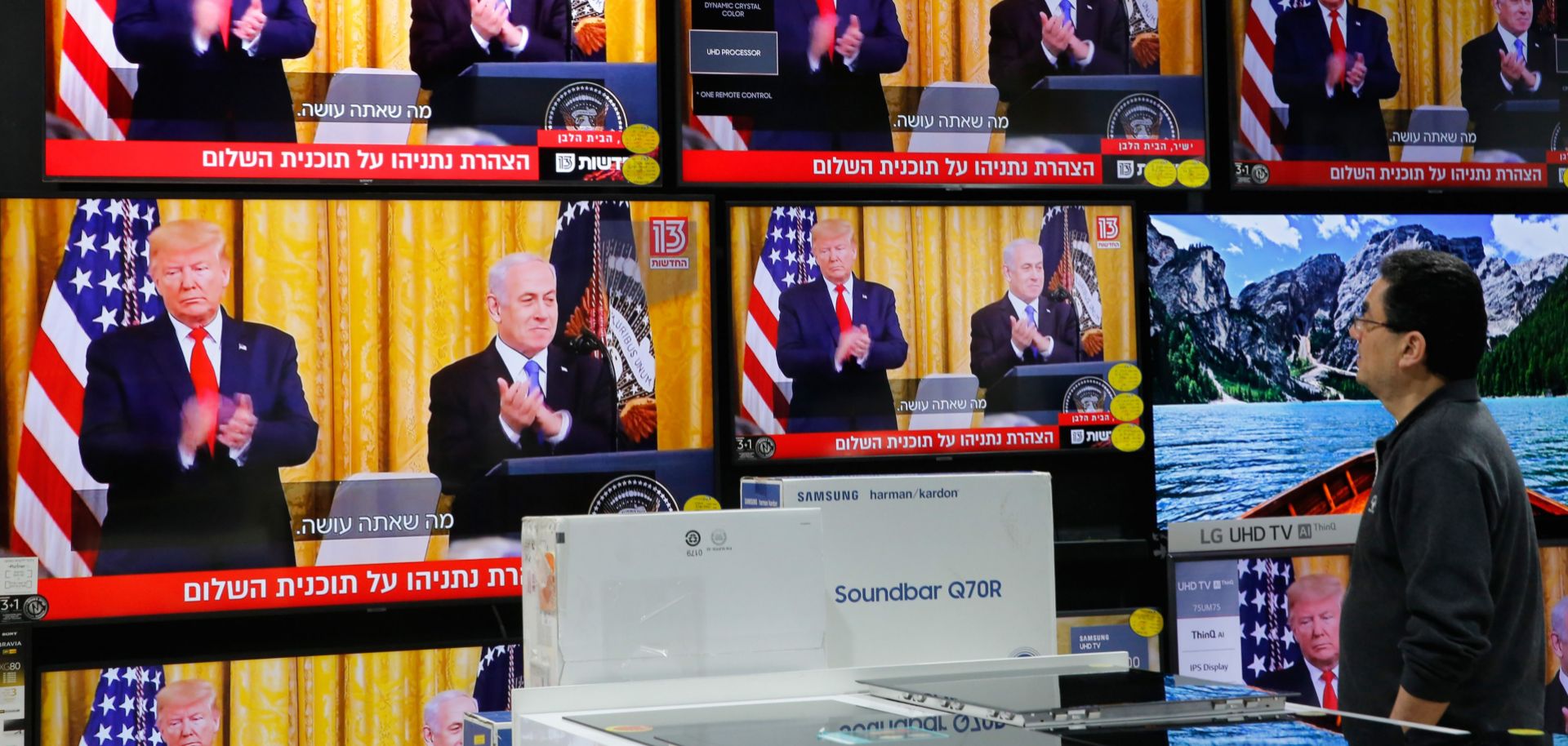 A man at an electronics store in Modiin, Israel, watches U.S. President Donald Trump and Israeli Prime Minister Benjamin Netanyahu unveil the Trump administration's Mideast peace plan during a White House news conference on Jan. 28, 2020.