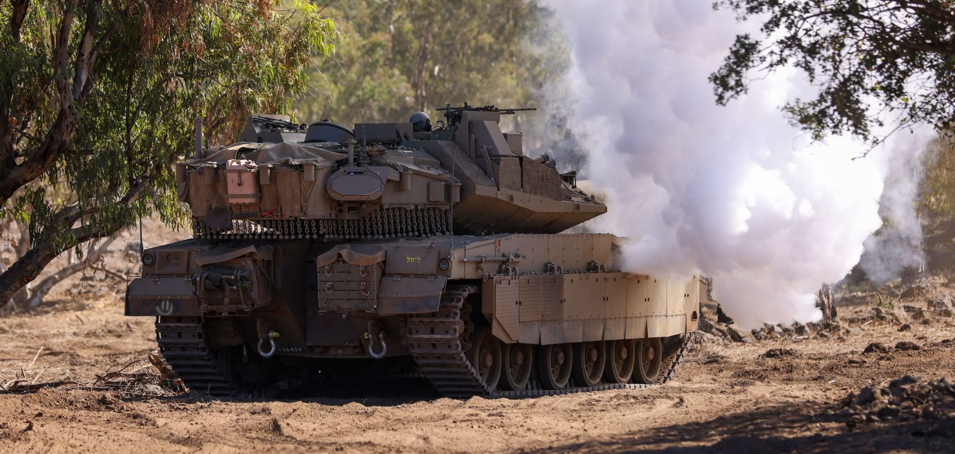 An Israeli tank moves into position during a drill in the annexed Golan Heights on Nov. 9, 2023, amid increasing cross-border tensions between Hezbollah and Israel as fighting continues in Israel's south with Hamas militants in the Gaza Strip.