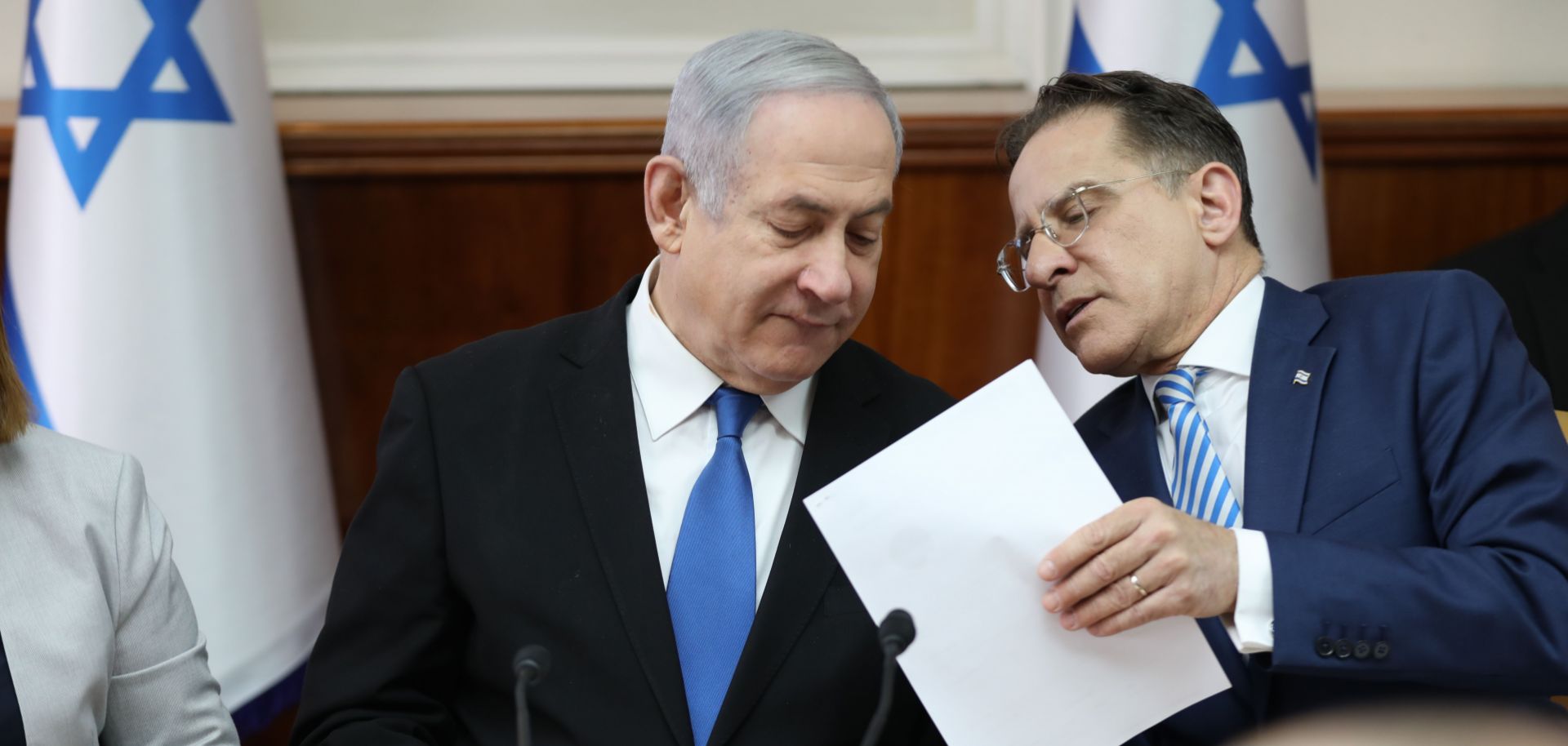 Israeli Prime Minister Benjamin Netanyahu, left, speaks with Cabinet Secretary Tzachi Braverman during a weekly Cabinet meeting in Jerusalem on Dec. 1, 2019.