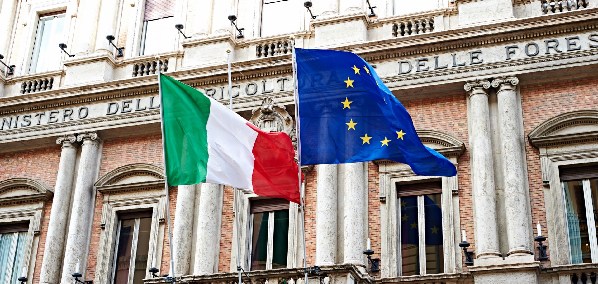 The Italian and EU flags are seen outside government buildings in Rome.