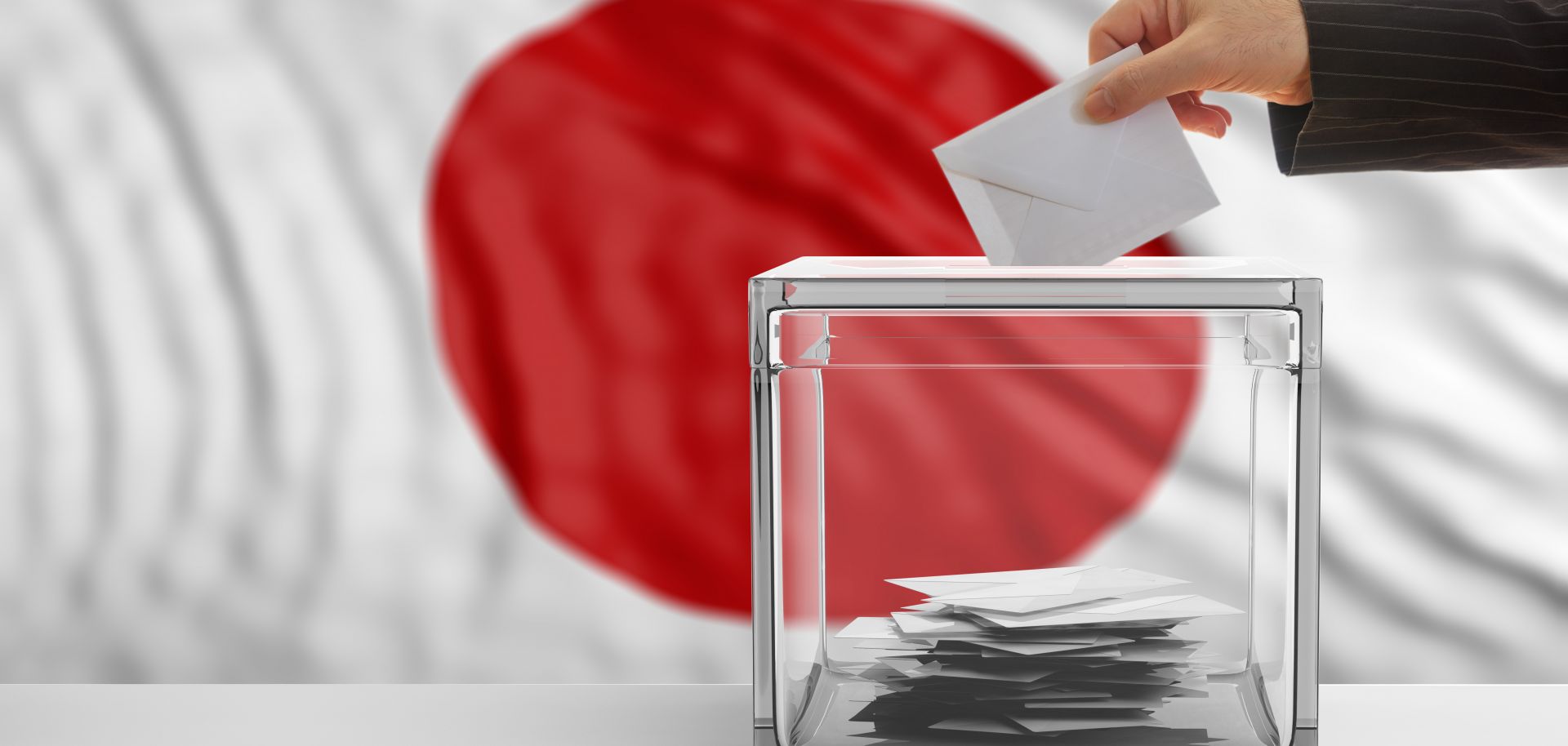 A ballot is cast in front of the Japanese flag.