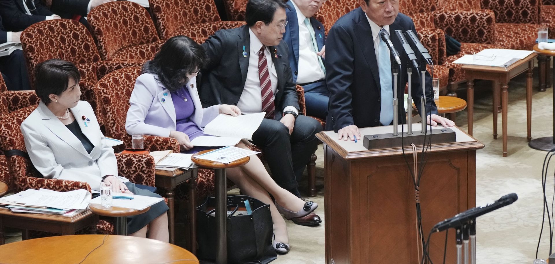 Japanese Foreign Minister Toshimitsu Motegi answers questions at a legislative budget committee session in Tokyo on April 7, 2026, while Prime Minister Sanae Takaichi (left) looks on. 