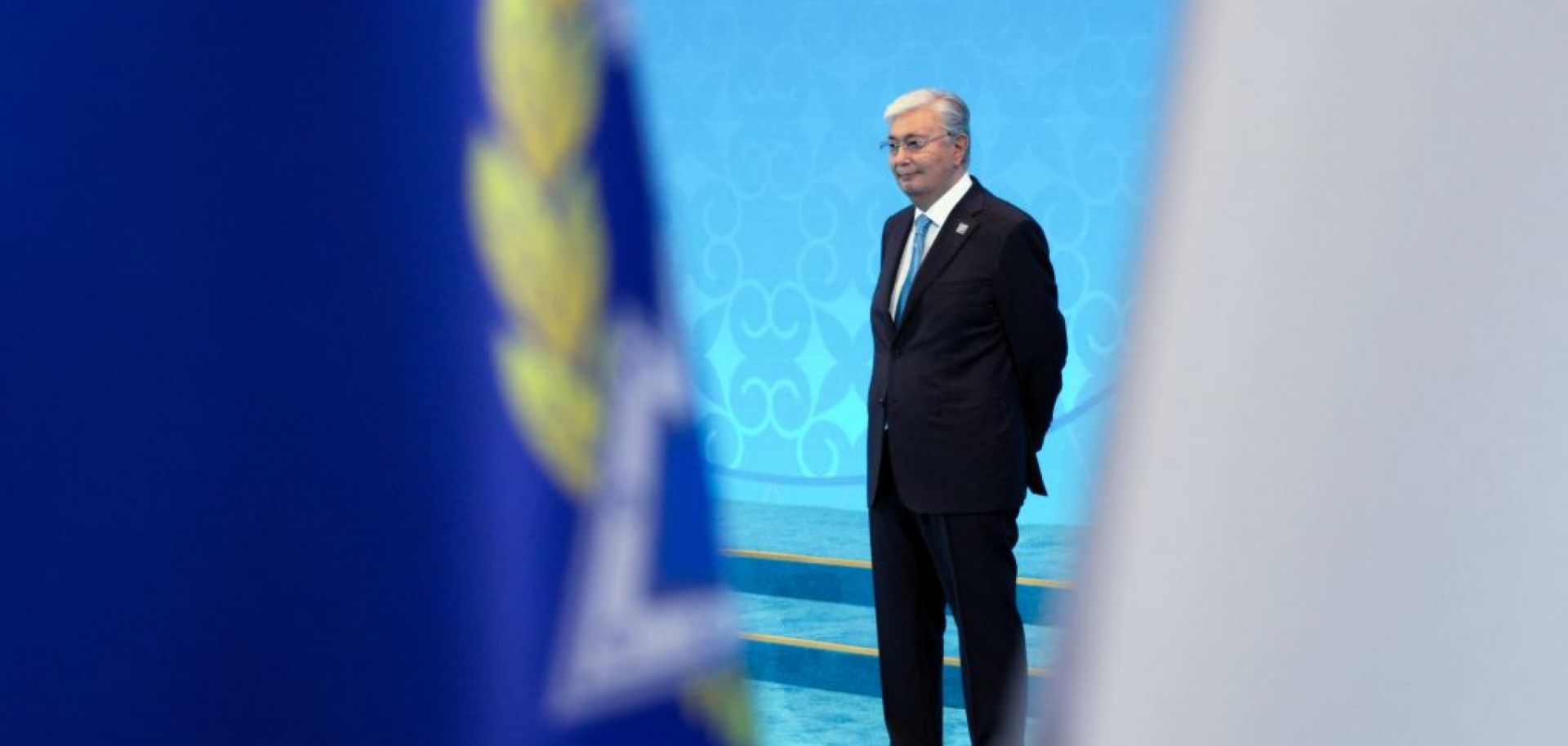 In this pool photograph distributed by the Russian state agency Sputnik, Kazakh President Kassym-Jomart Tokayev waits to greet foreign leaders during the Shanghai Cooperation Organization member states leaders' summit in Astana on July 4, 2024.