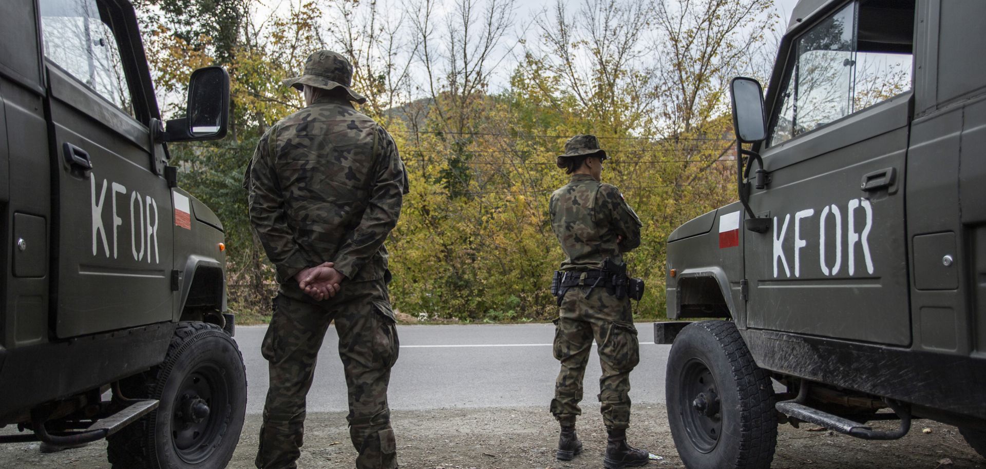 NATO soldiers patrol a road near the town of Zvecan in northern Kosovo on Oct. 12, 2022.