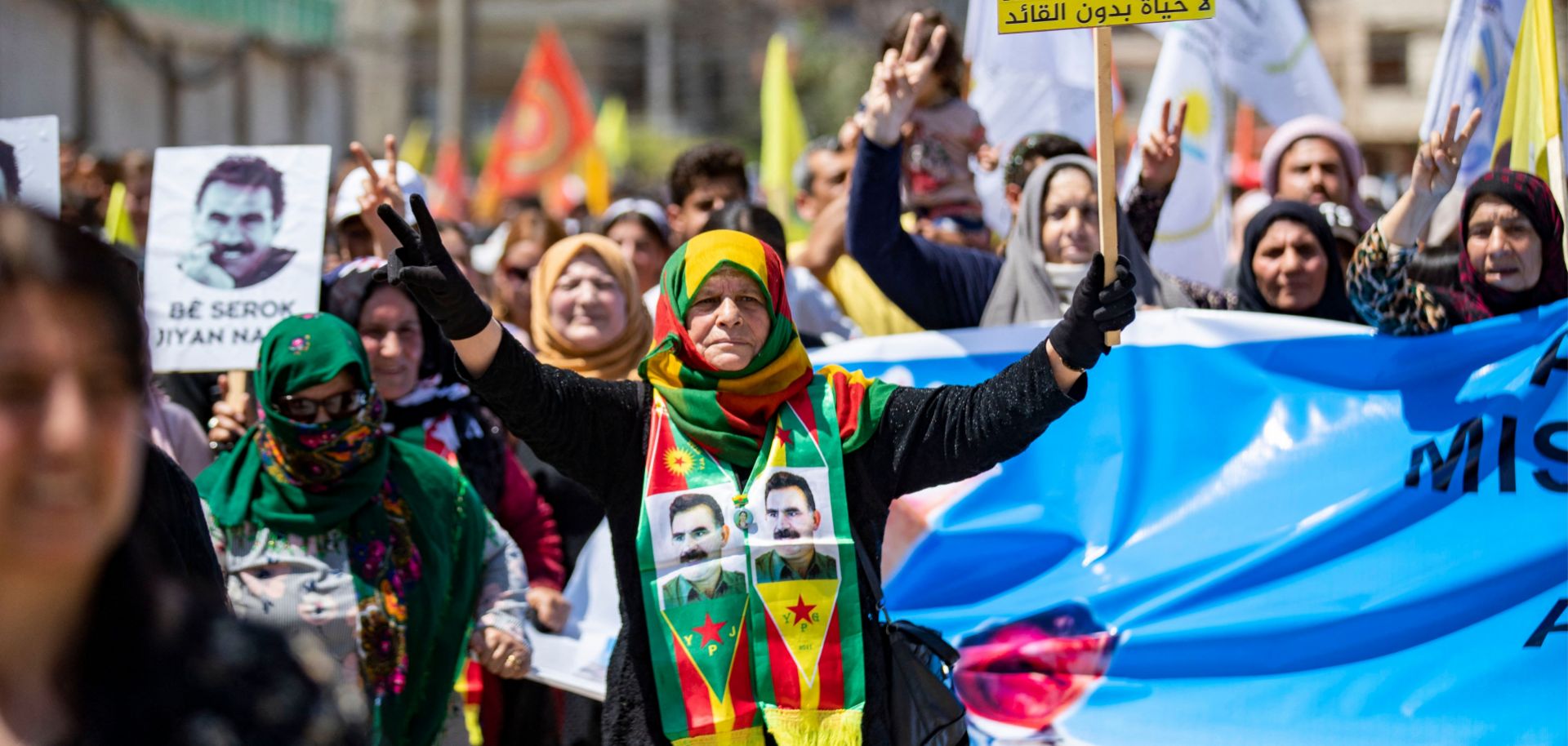 Syrian Kurds gather in the northeastern city of Qamishli on May 10, 2023, to show their support for the Turkish opposition ahead of Turkey's election. Images of Abdullah Ocalan, the leader of the Kurdistan Worker's Party (PKK), are seen on some demonstrators' placards and clothing.