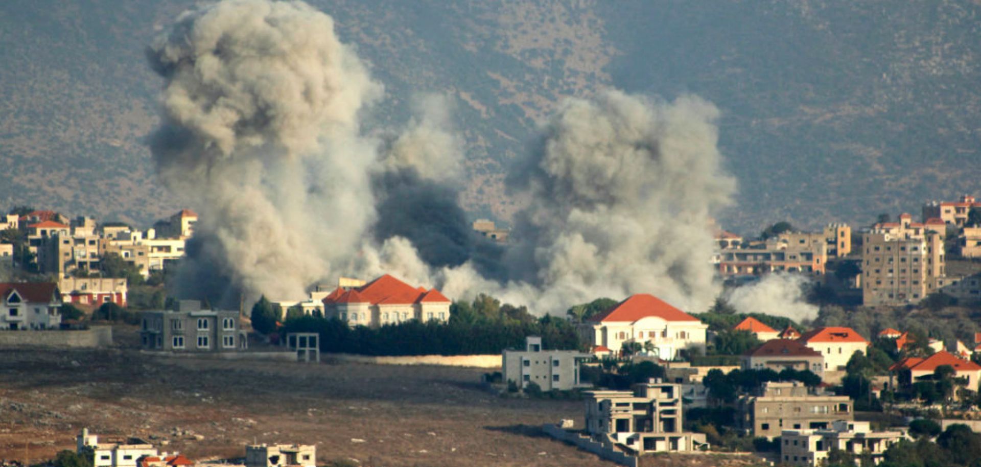 A plume of smoke billows following an Israeli air strike above a border town in southern Lebanon on Oct. 7, 2024. 