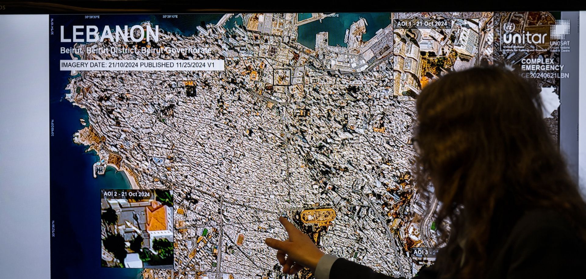 U.N. Satellite Center cultural heritage analyst Michelle de Gruchy gestures next to a map of Beirut, Lebanon, during a press conference in Geneva, Switzerland, on monitoring damage to cultural heritage in Lebanon and Gaza on Nov. 25, 2024.