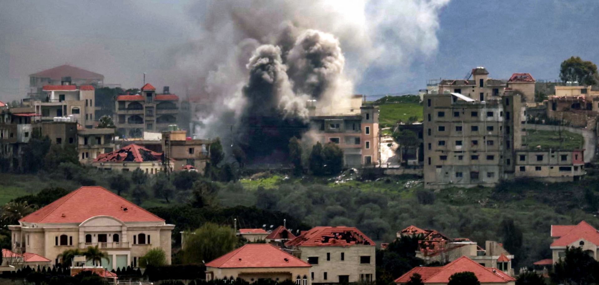 Smoke plumes rise above a village in southern Lebanon following Israeli airstrikes on March 16, 2026.