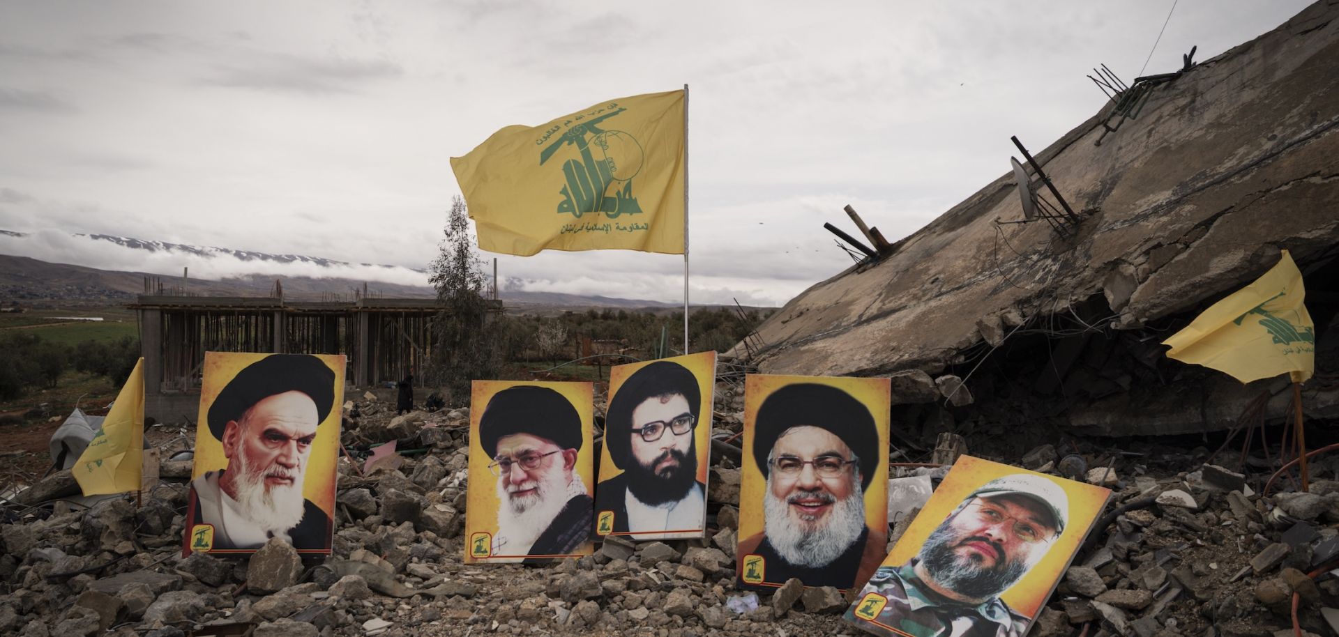 Photos of prominent Hezbollah leaders are seen at the site of a reported Israeli airstrike which killed 6 members of the same family, on March 19, 2026 in Baalbek, Lebanon.
