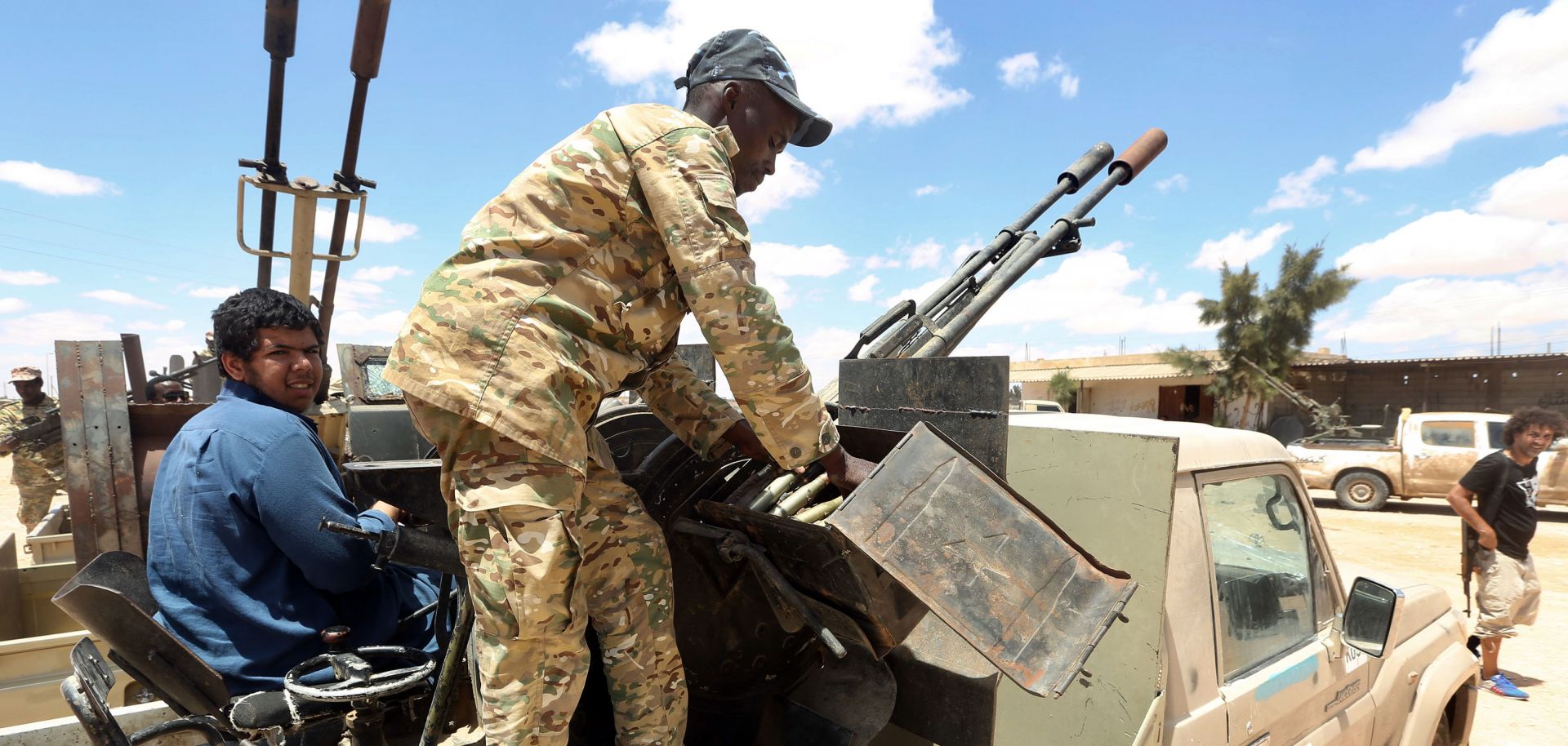 Fighters aligned with Libya's internationally-recognized Government of National Accord (GNA) patrol a village located halfway between Tripoli and Benghazi on July 20, 2020.