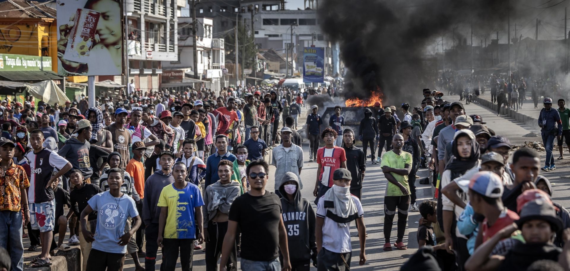 Protesters face police from a distance near burning barricades in Antananarivo, Madagascar, on Oct. 9, 2025. 