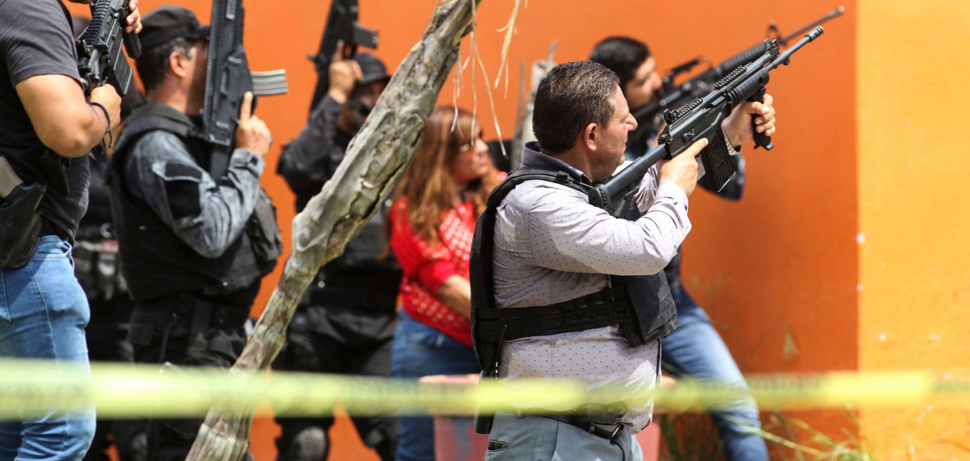 Mexican police take position outside a house during a search in Tlajomulco de Zuniga, Jalisco State, Mexico, on June 21, 2019.