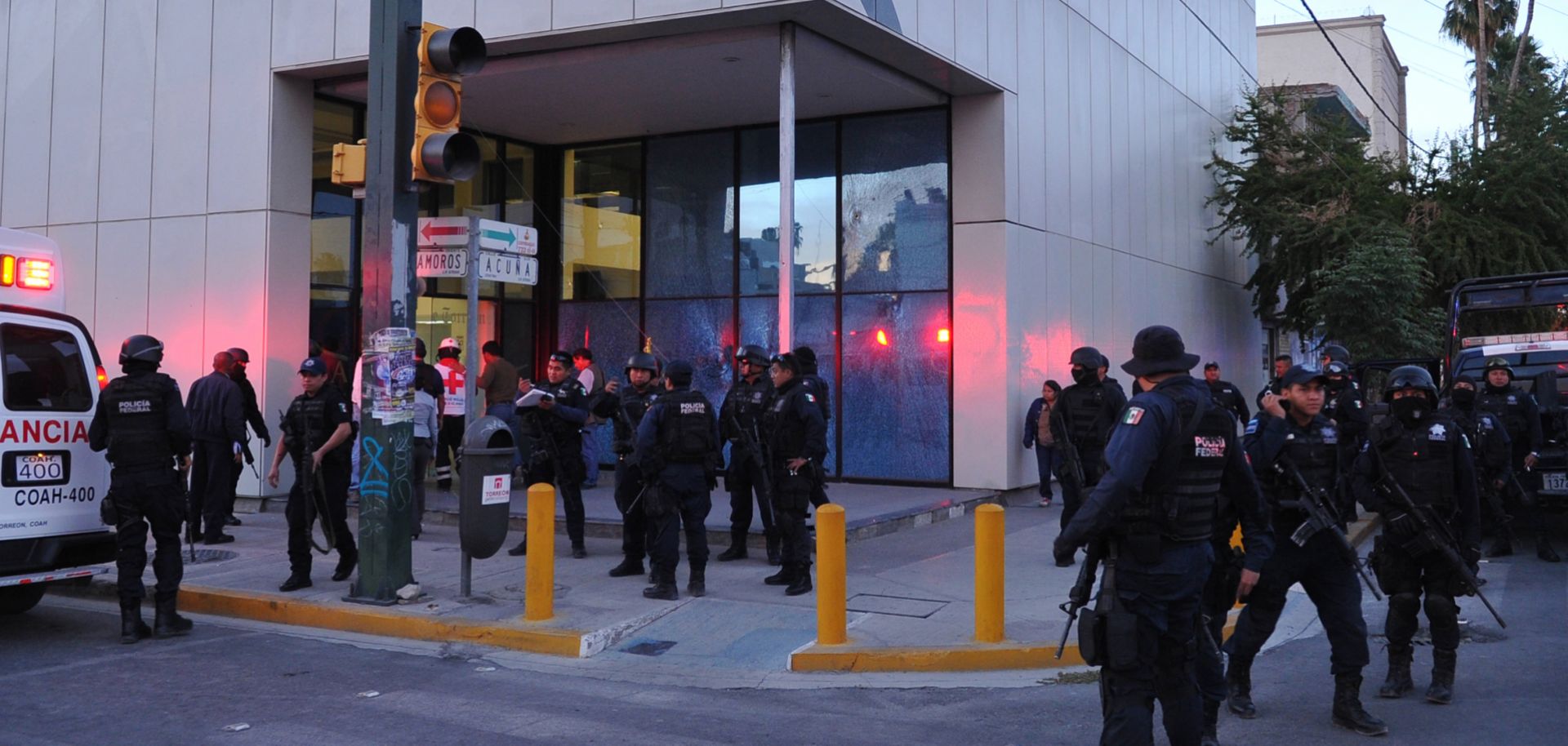 Members of Mexican federal police stand guard in the main entrance of the El Siglo de Torreon Newspaper, in Torreon, Coahuila State, on February 26, 2013. 