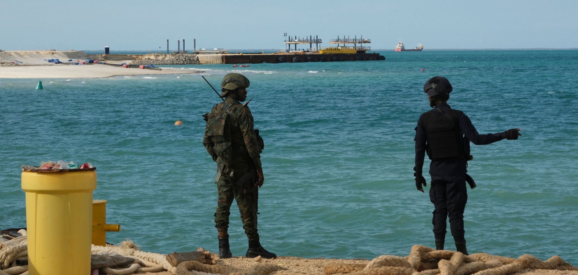A Rwandan policeman (R) and a Rwandan soldier (L) guard TotalEnergies' Mozambique LNG project in Cabo Delgado province, Mozambique, on Sept. 29, 2022.
