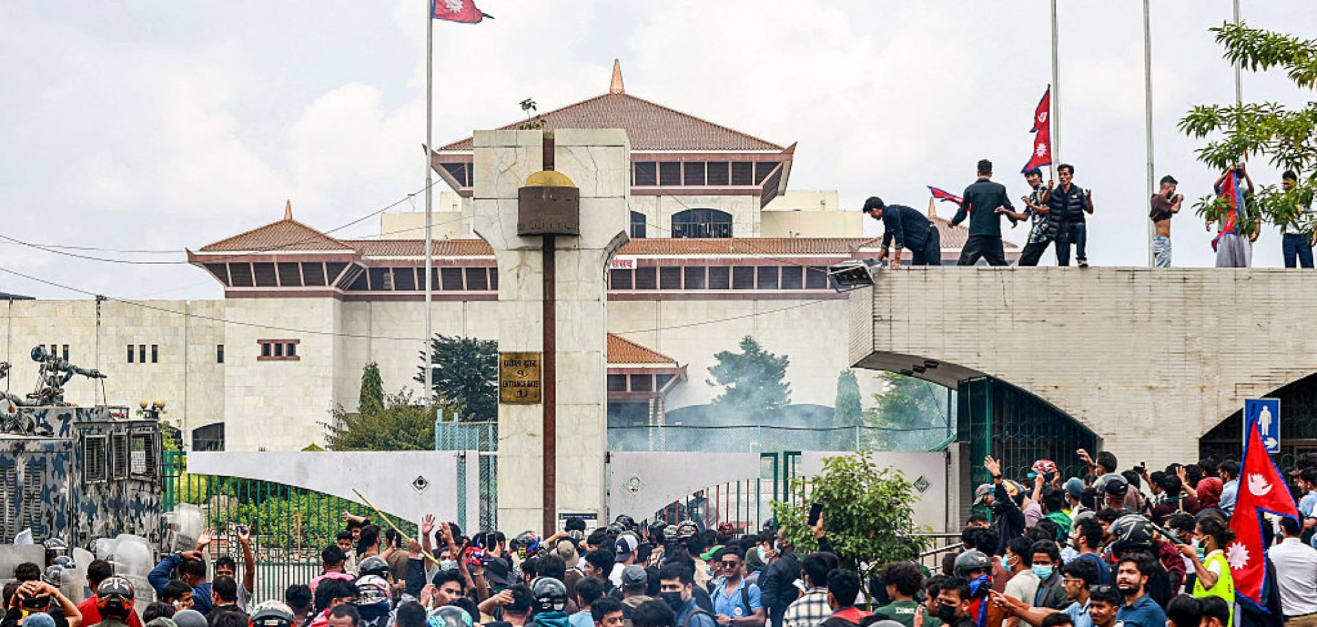 Demonstrators carrying Nepal's national flag stage a protest outside the parliament building in Kathmandu on Sept. 8, 2025, against social media prohibitions and government corruption. 