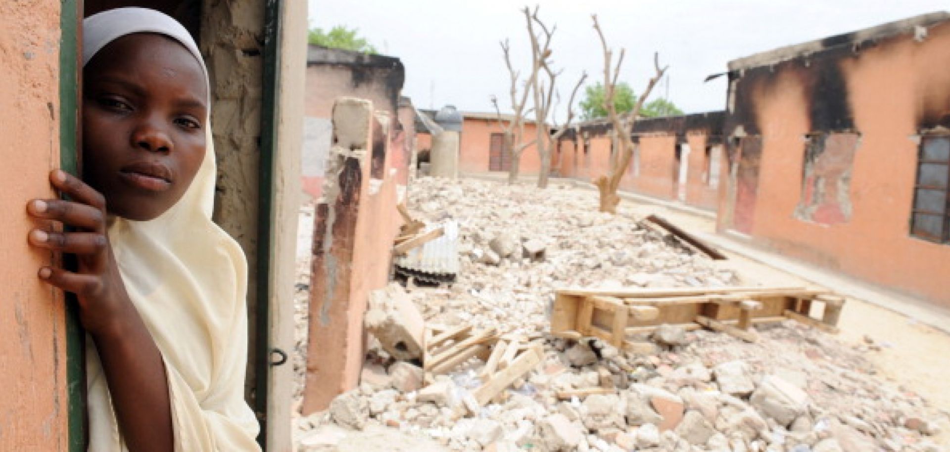 A student stands in what’s left of her school after Boko Haram burned it down in northeastern Nigeria. 