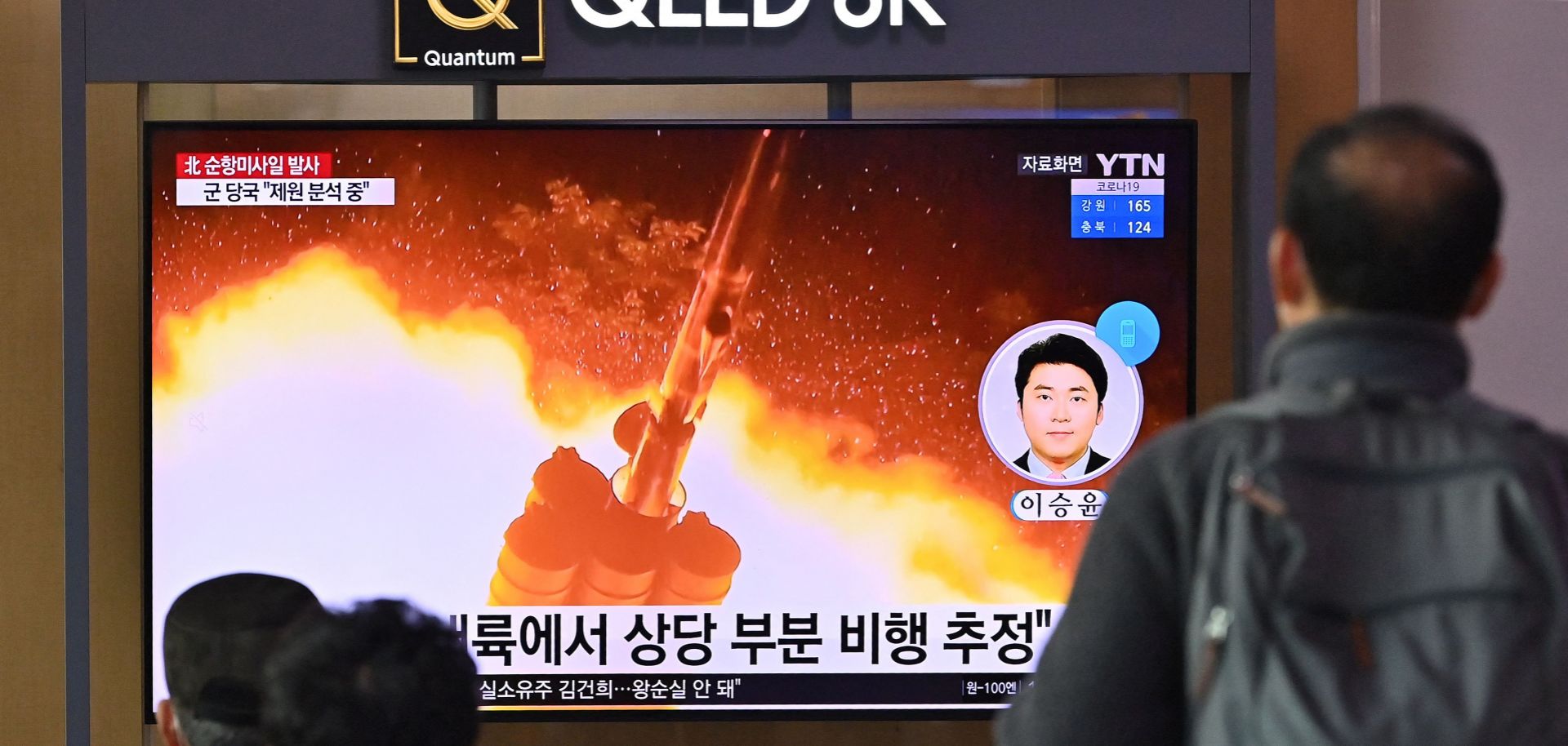 People watch a news broadcast with file footage of a missile test at a railway station in Seoul on Jan. 25, 2022, after North Korea fired two suspected cruise missiles according to South Korea's military. 