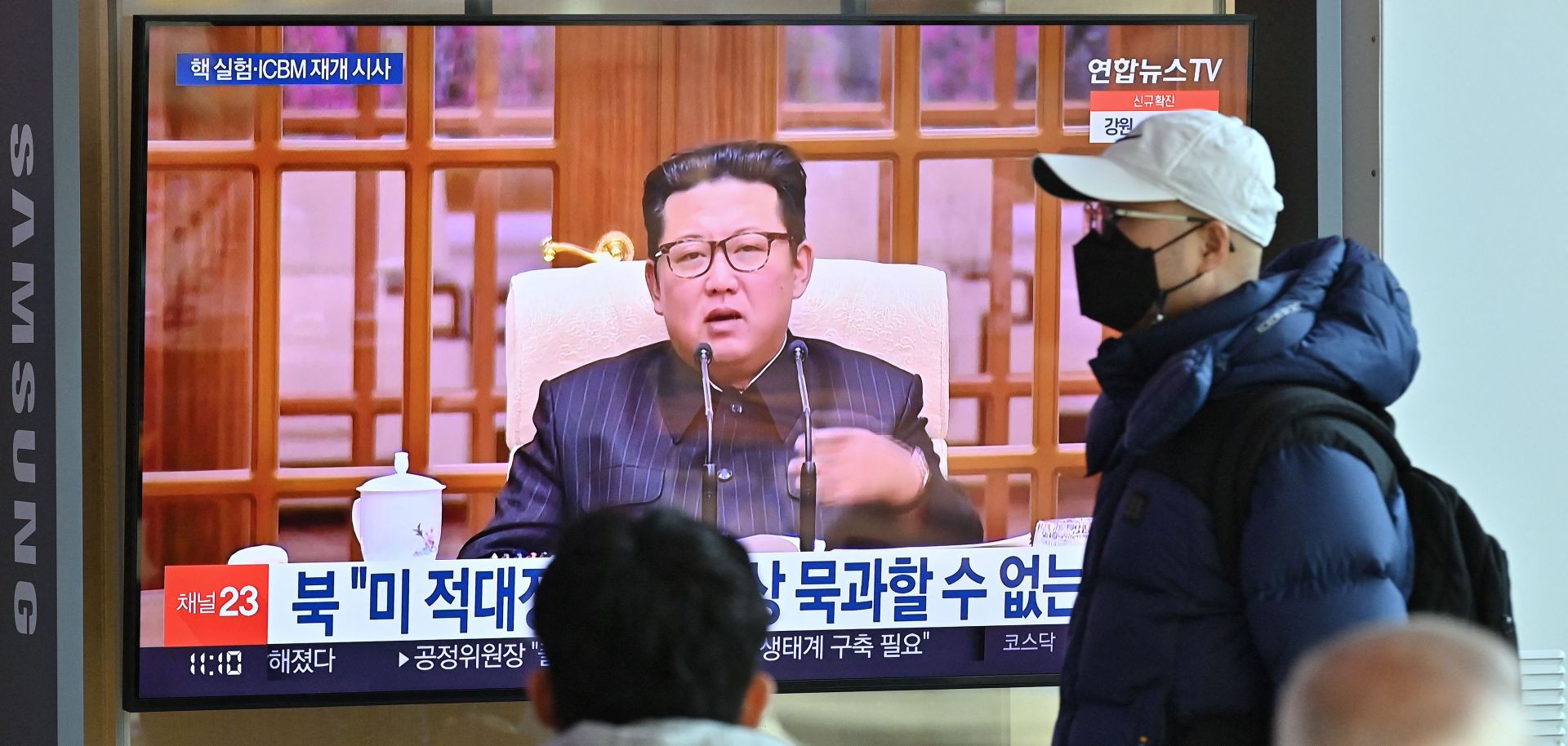 People watch a television screen showing a news broadcast with file footage of North Korean leader Kim Jong Un, at a railway station in Seoul, South Korea, on Jan. 20, 2022, after North Korea hinted it could resume nuclear and long-range weapons tests. 
