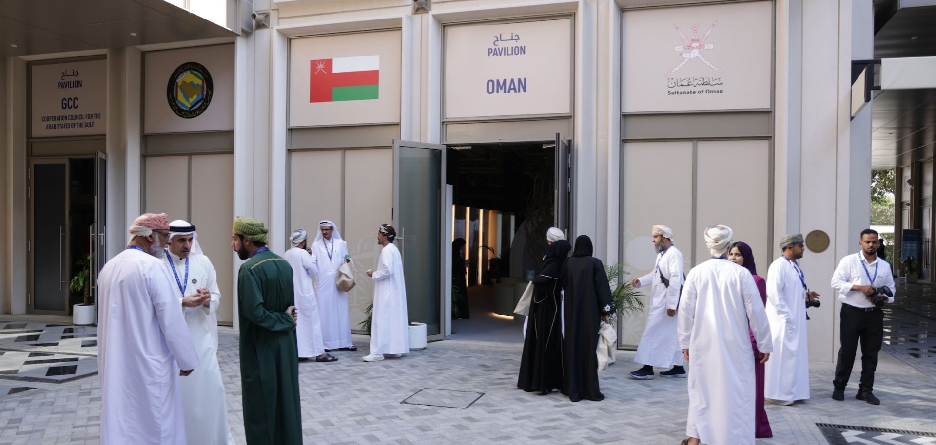 Participants stand outside the pavilion of Oman as they attend day nine of the U.N. Climate Change Conference in Dubai, United Arab Emirates, on Dec. 9, 2023. 