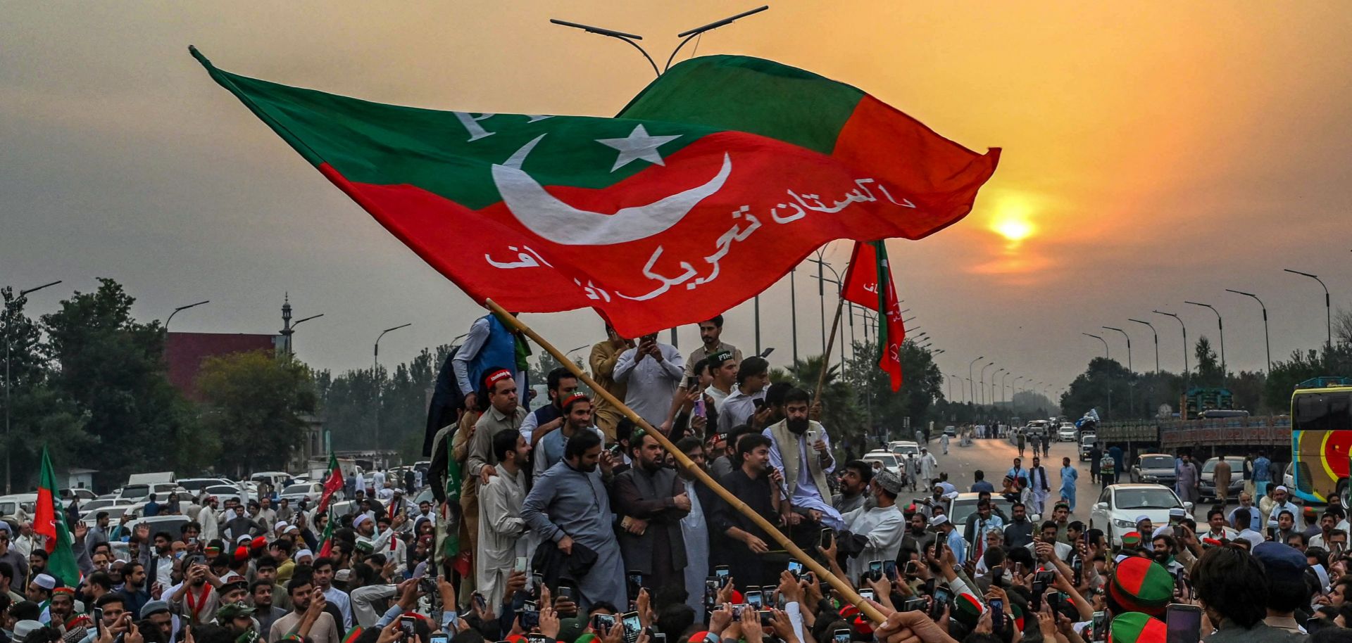 Supporters of former Pakistani Prime Minister Imran Khan take part in a protest as they block the main road in Peshawar, Pakistan, a day after the assassination attempt on Khan on Nov. 4, 2022. 