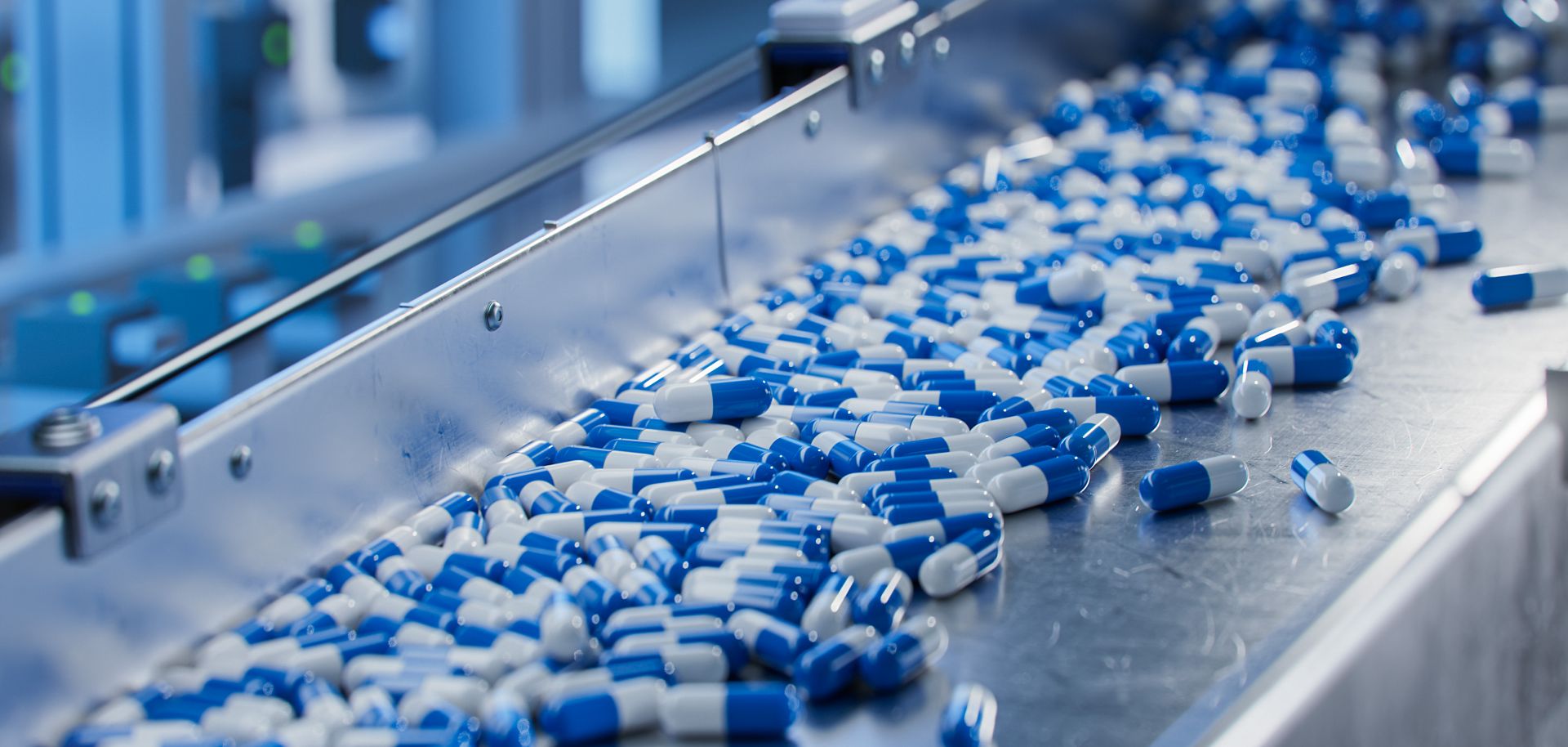A stock photo shows blue capsules on a conveyor at a pharmaceutical factory.